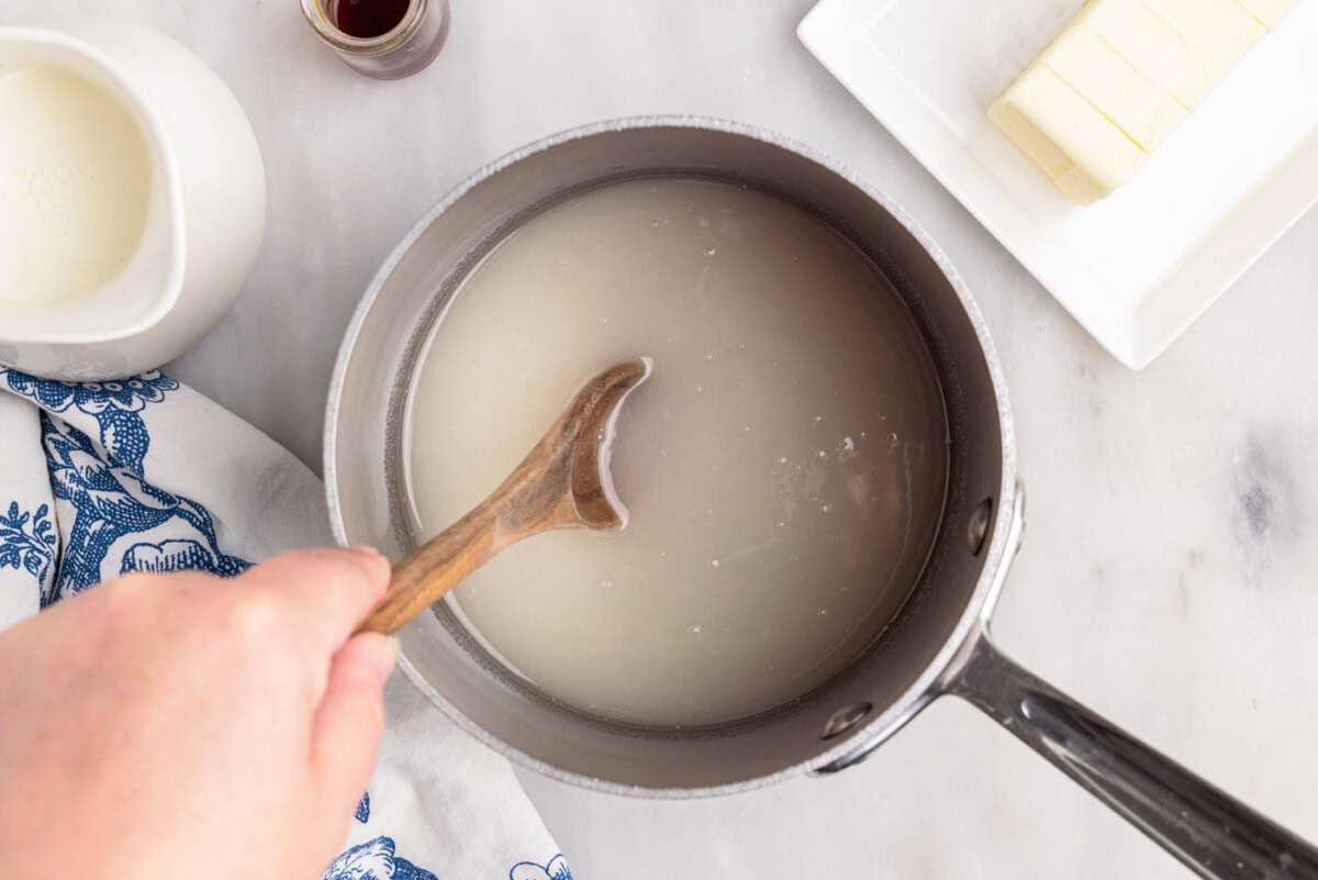 stirring corn syrup, sugar, and water in a saucepan