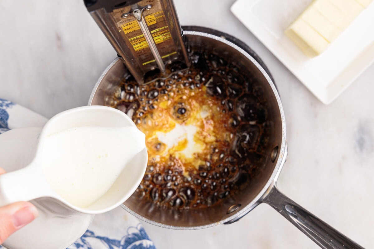heavy cream pouring into caramel sauce