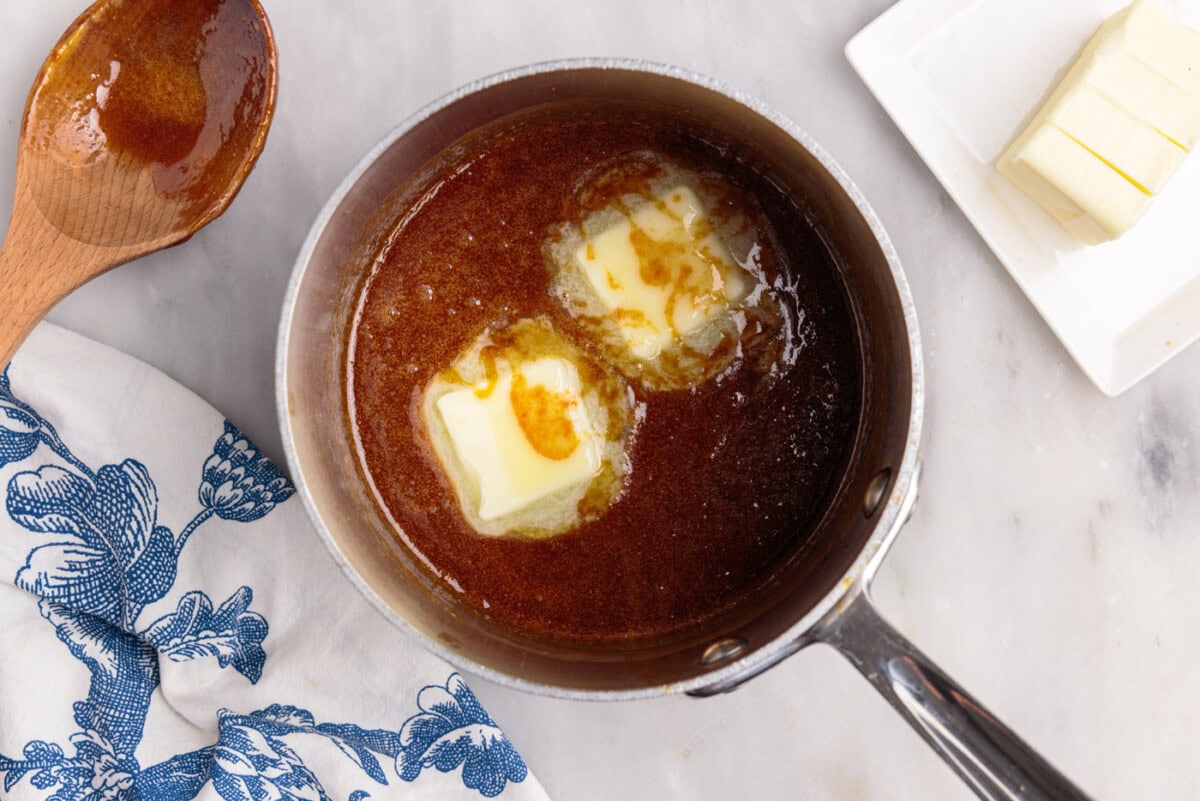 adding butter to caramel sauce