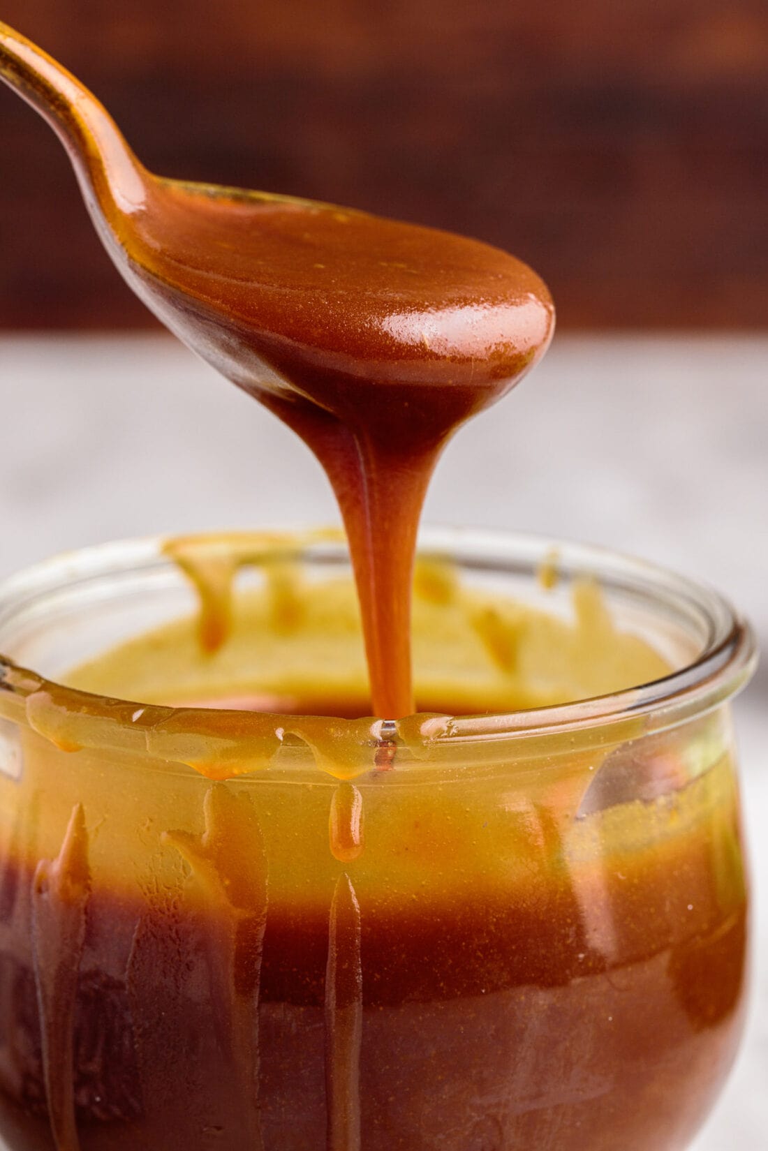 Spooning out some Caramel Sauce from a jar