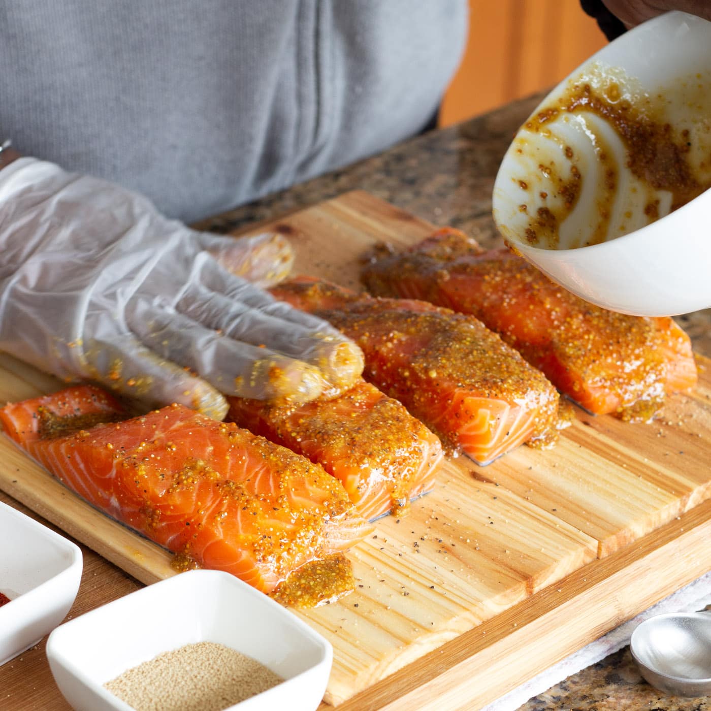 rubbing salmon filets with marinade
