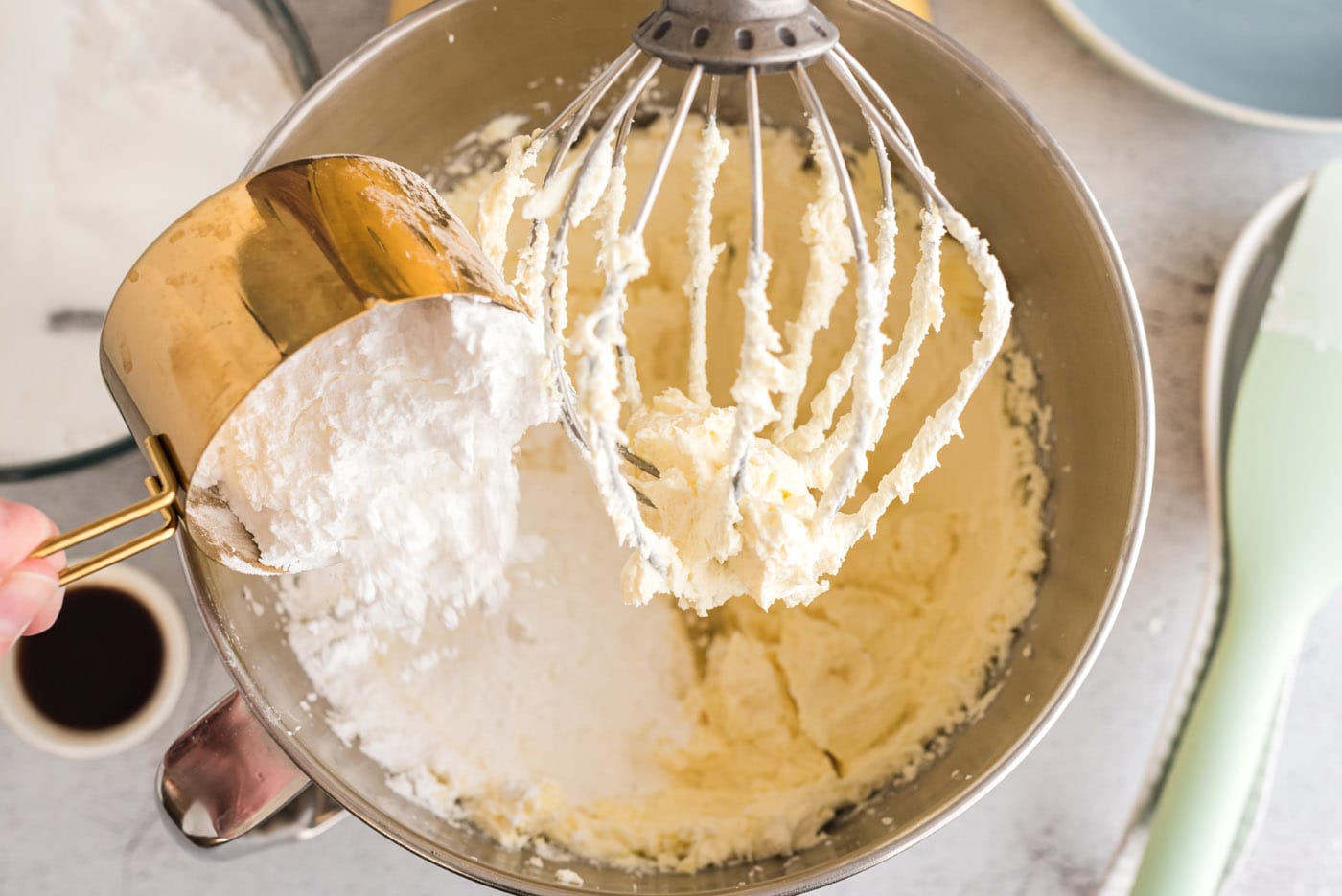 adding powdered sugar to cream cheese and butter mixture
