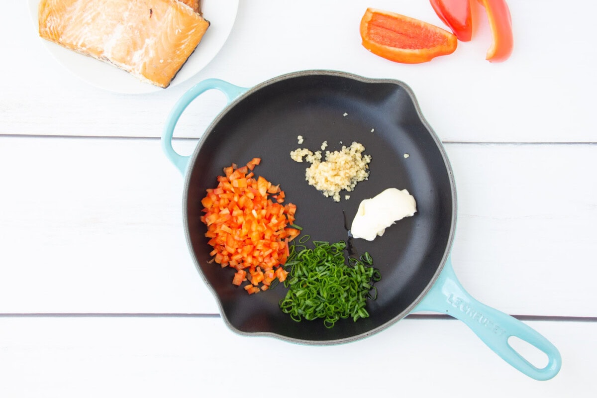 bell pepper, green onion, garlic, and butter in a skillet