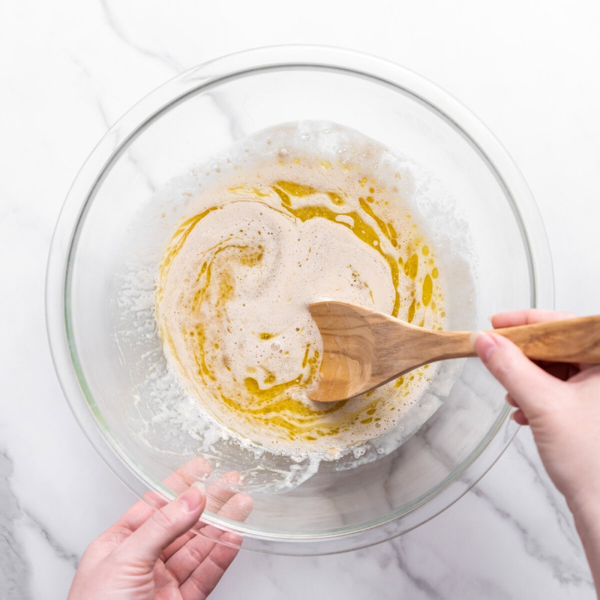 mixing ingredients into yeast in a bowl