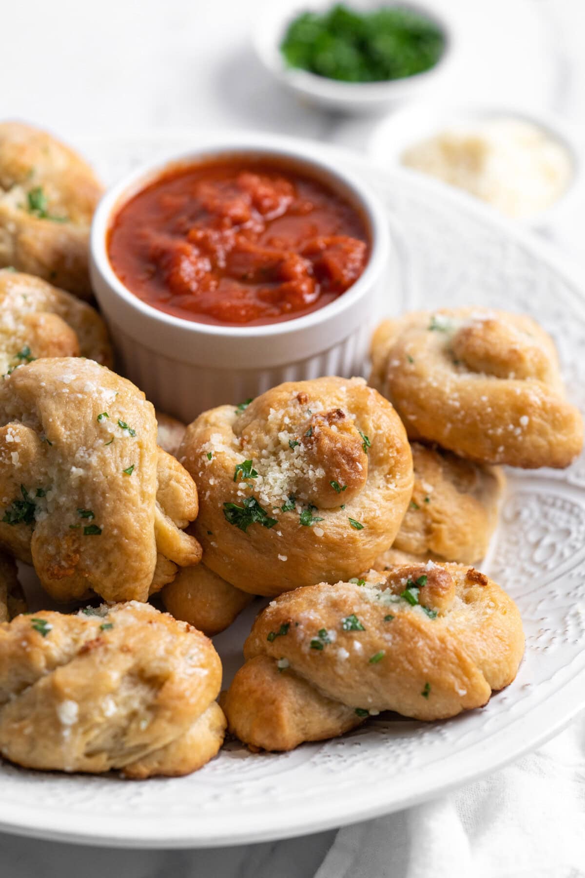 garlic knots on a plate with marinara