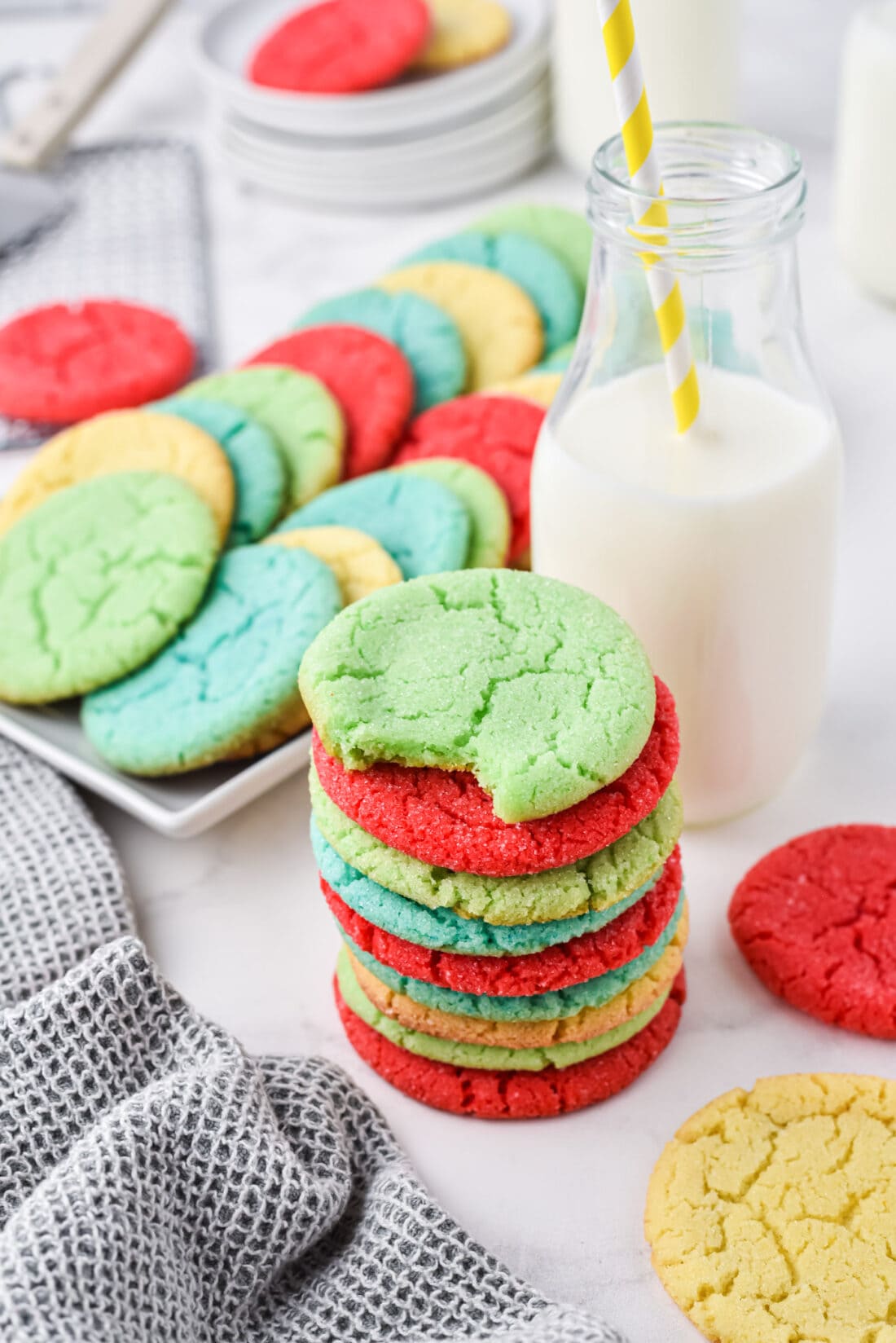 stack of Jello Cookies with a plate of cookies in back