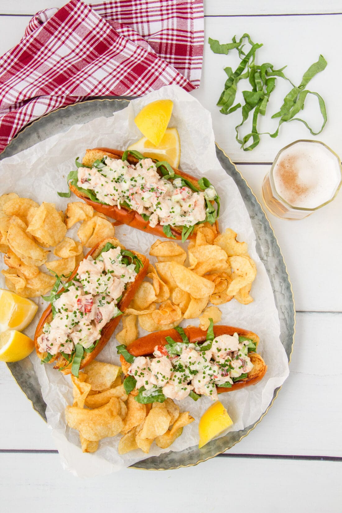 3 Lobster Rolls on a large platter with potato chips