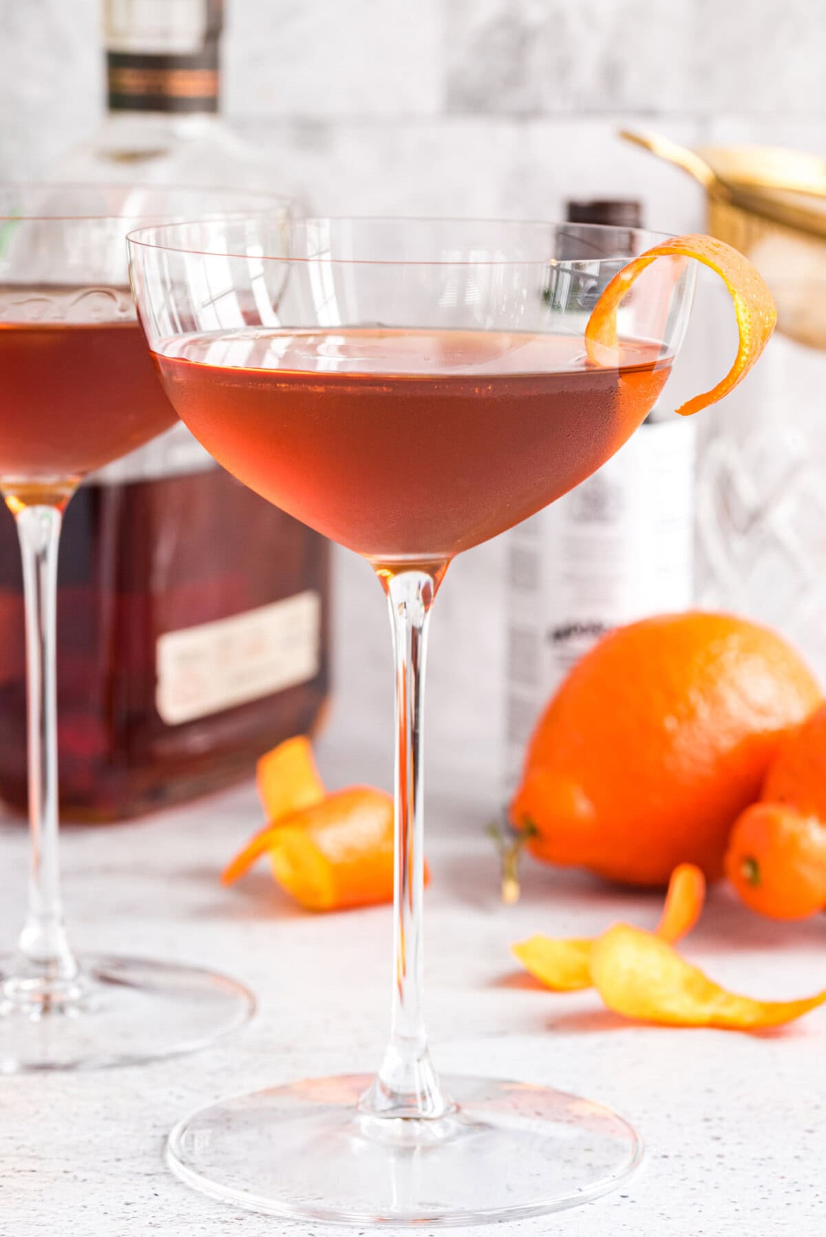 Manhattan Cocktail with liquor bottles in background