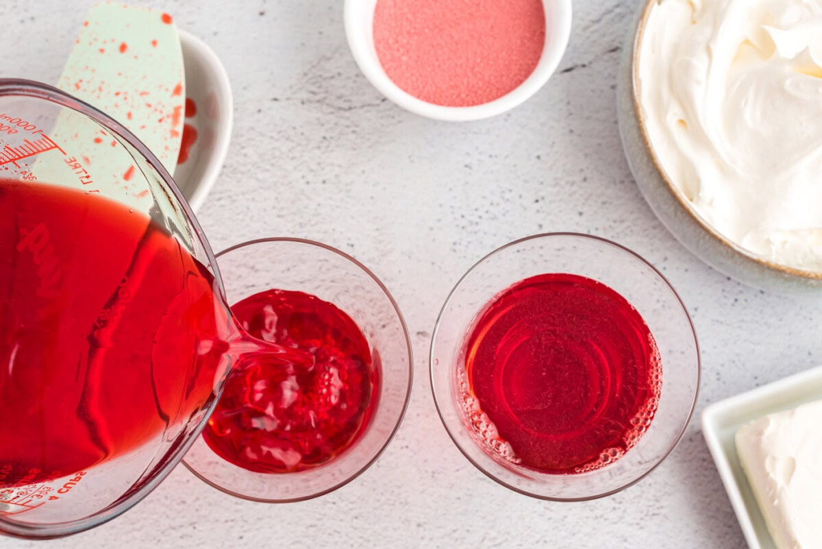 pouring jello mixture into trifle dishes
