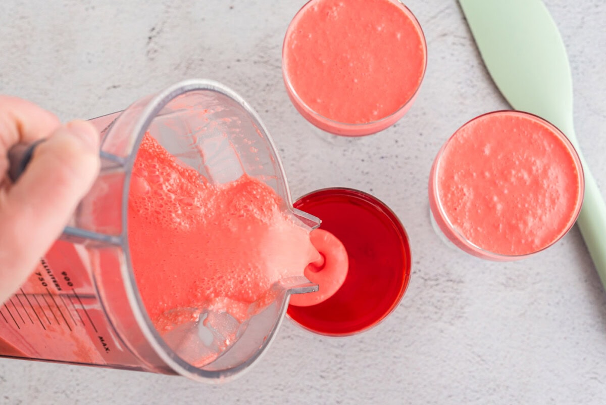 pouring creamy jello into small trifle dishes