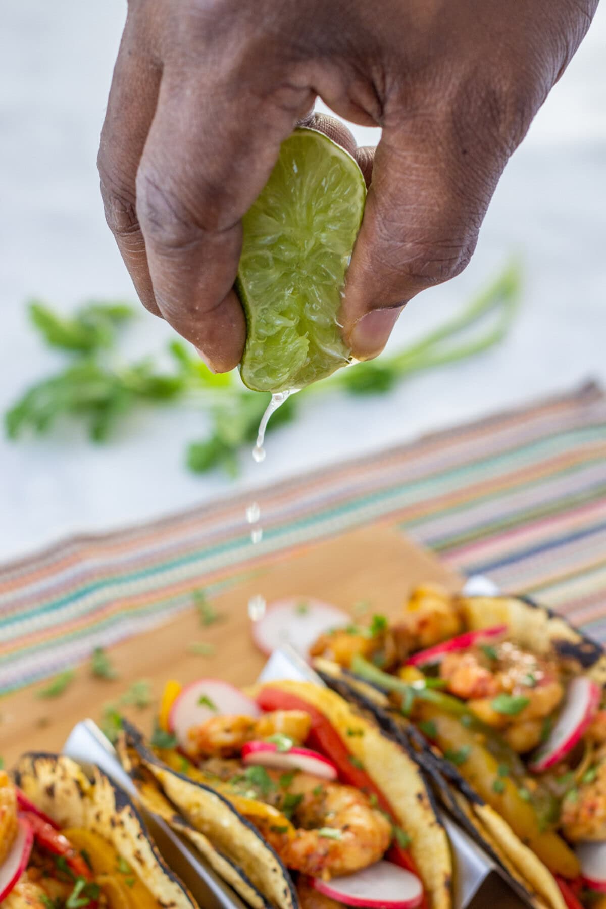 squeezing lime onto Shrimp Fajitas