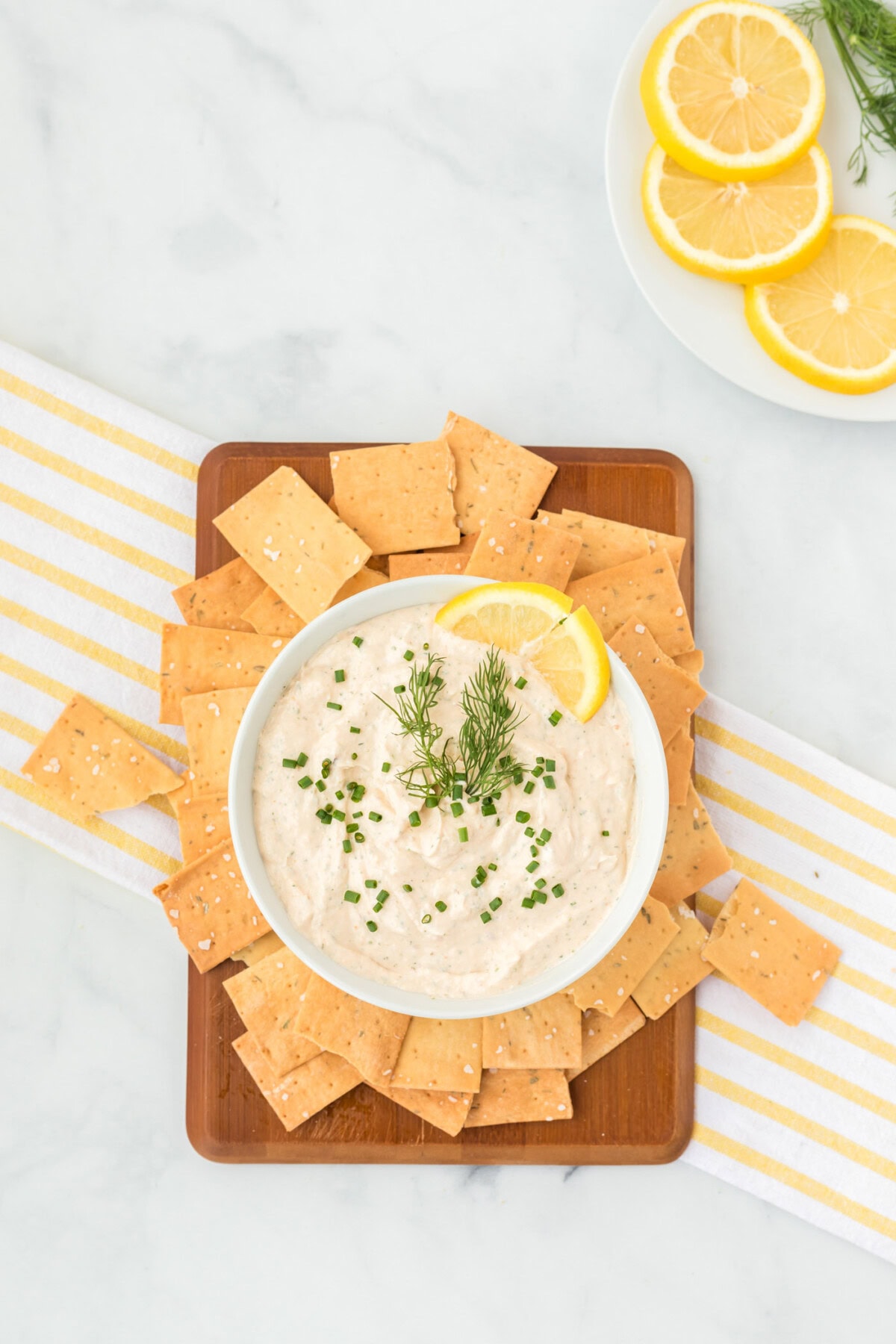 Smoked Salmon Dip in a bowl on a small cutting board