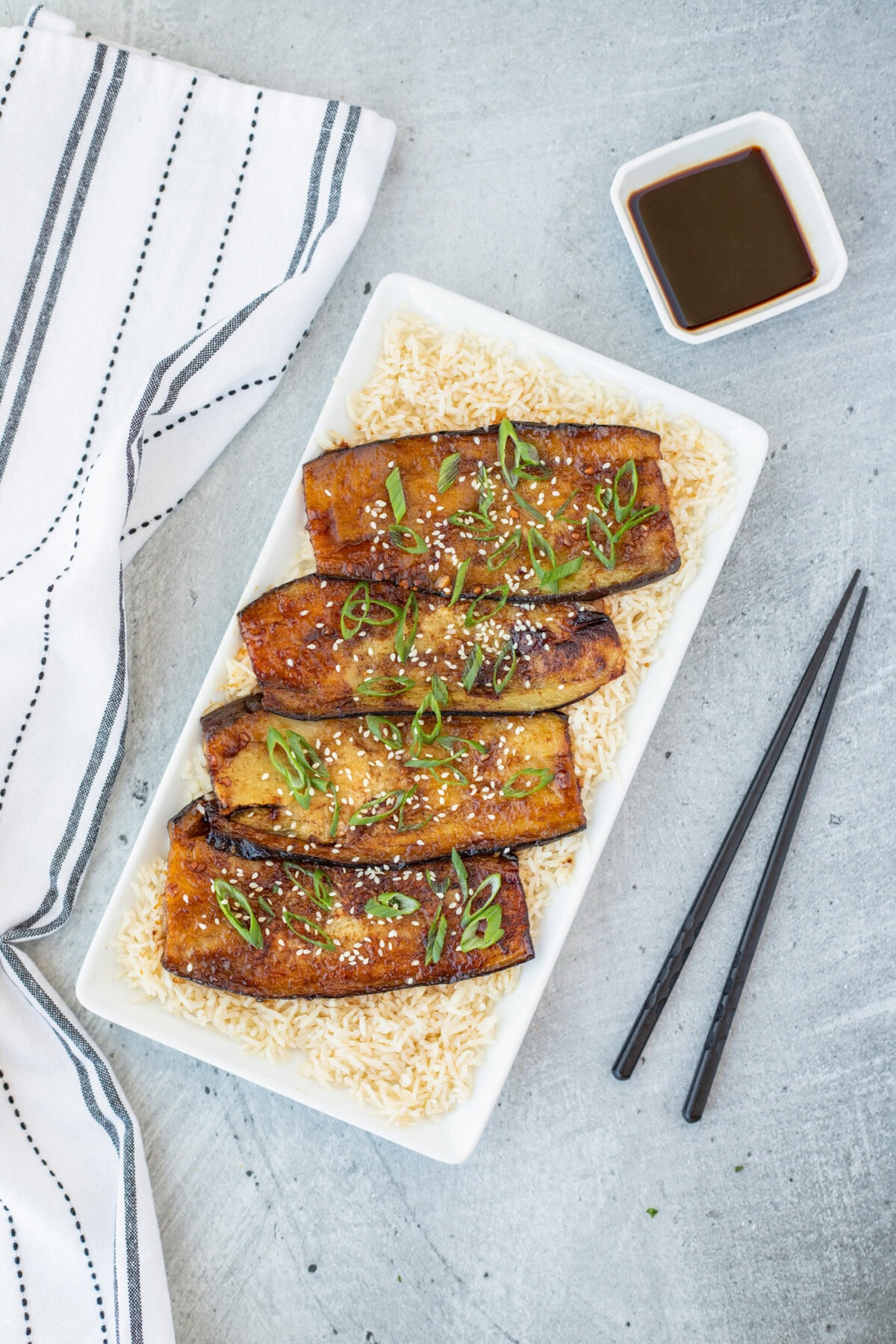 Soy Glazed Eggplant over rice on a plattter