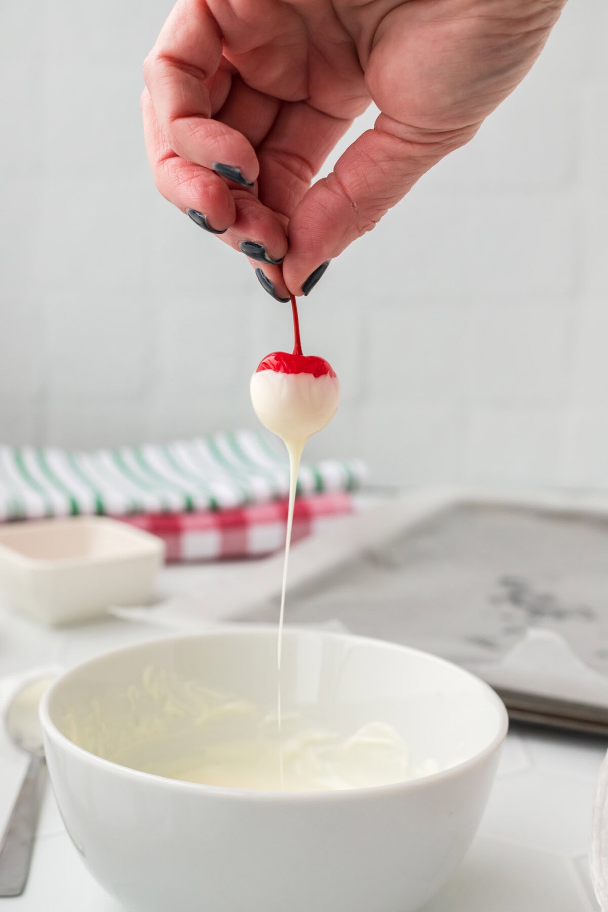 dipping boozy cherry into chocolate