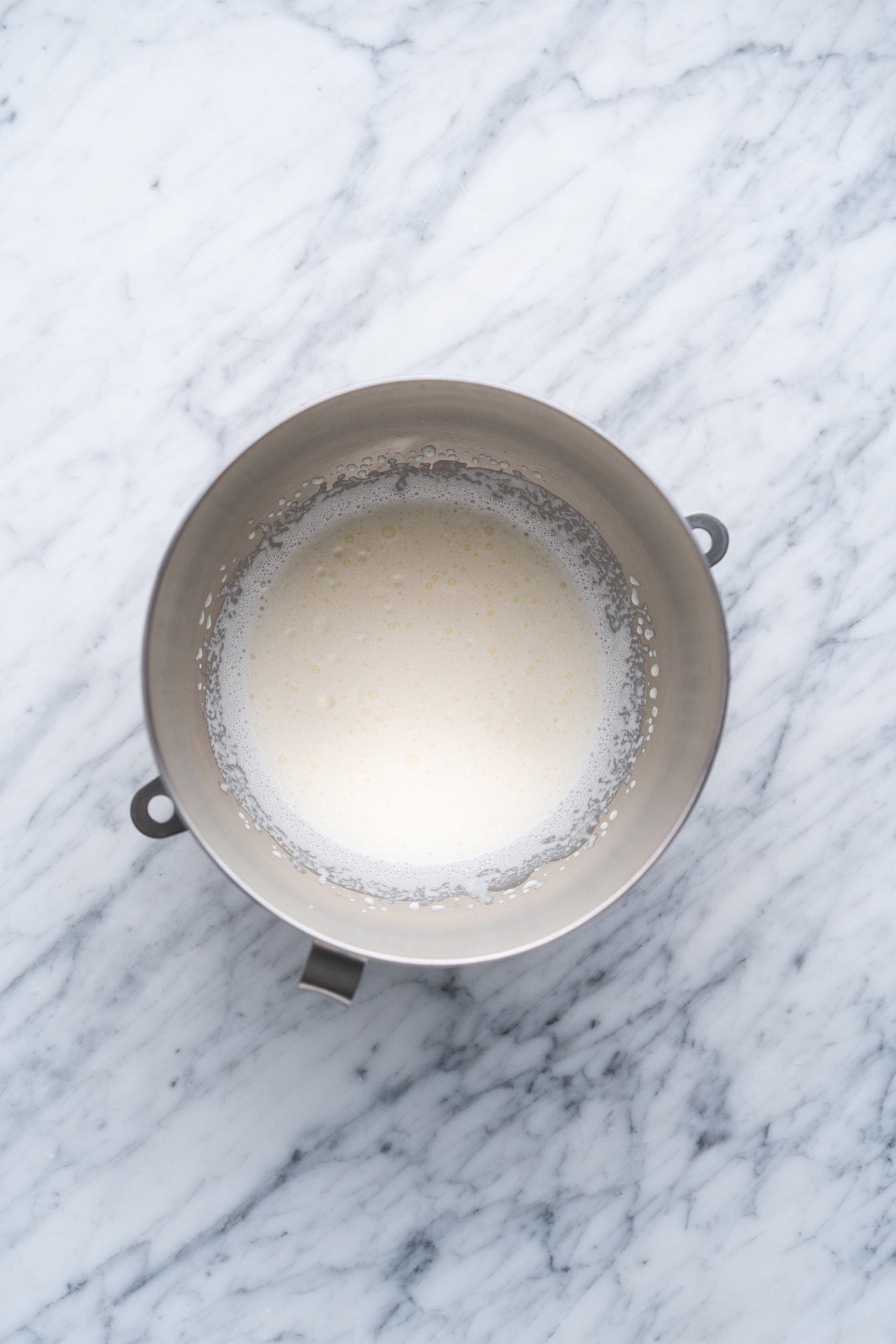 heavy whipping cream frothed in a mixing bowl