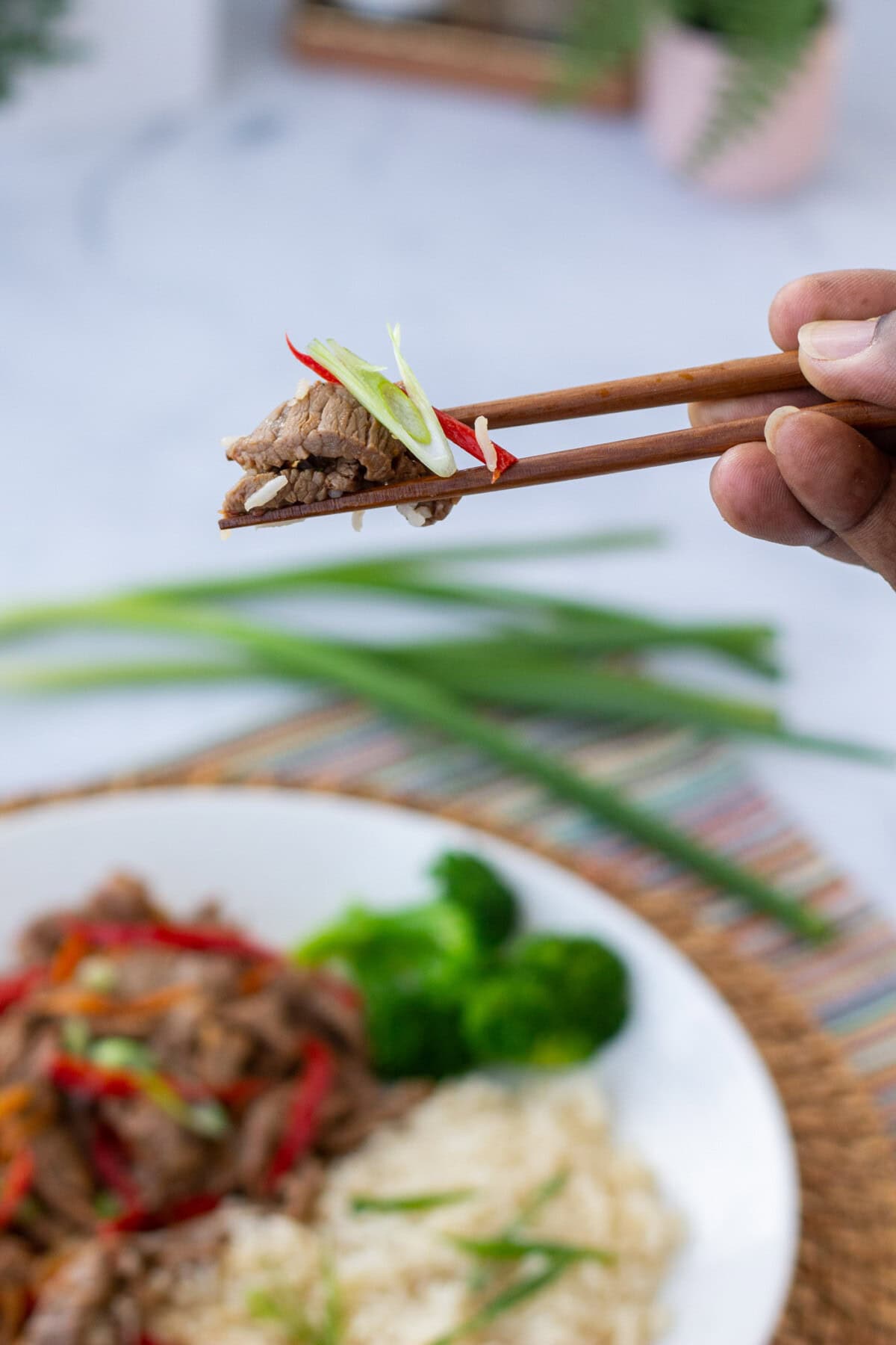 picking up Szechuan Beef with chopsticks