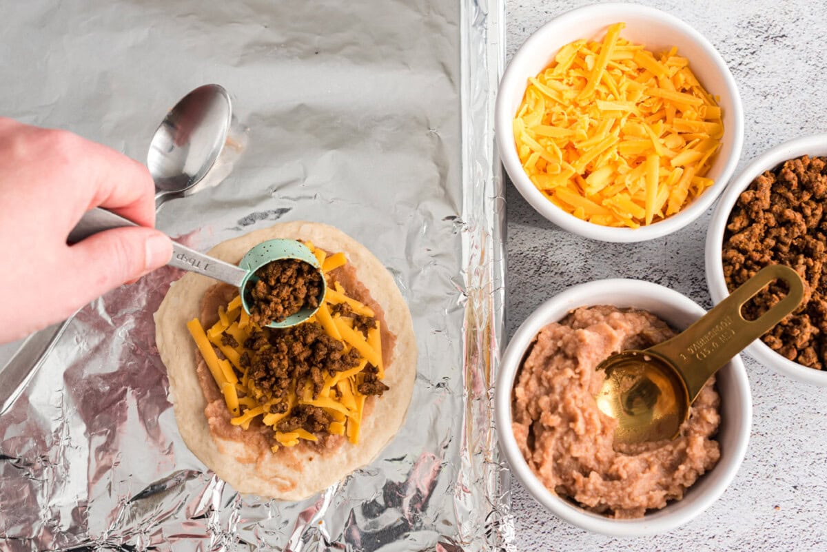 adding taco meat to empanadas