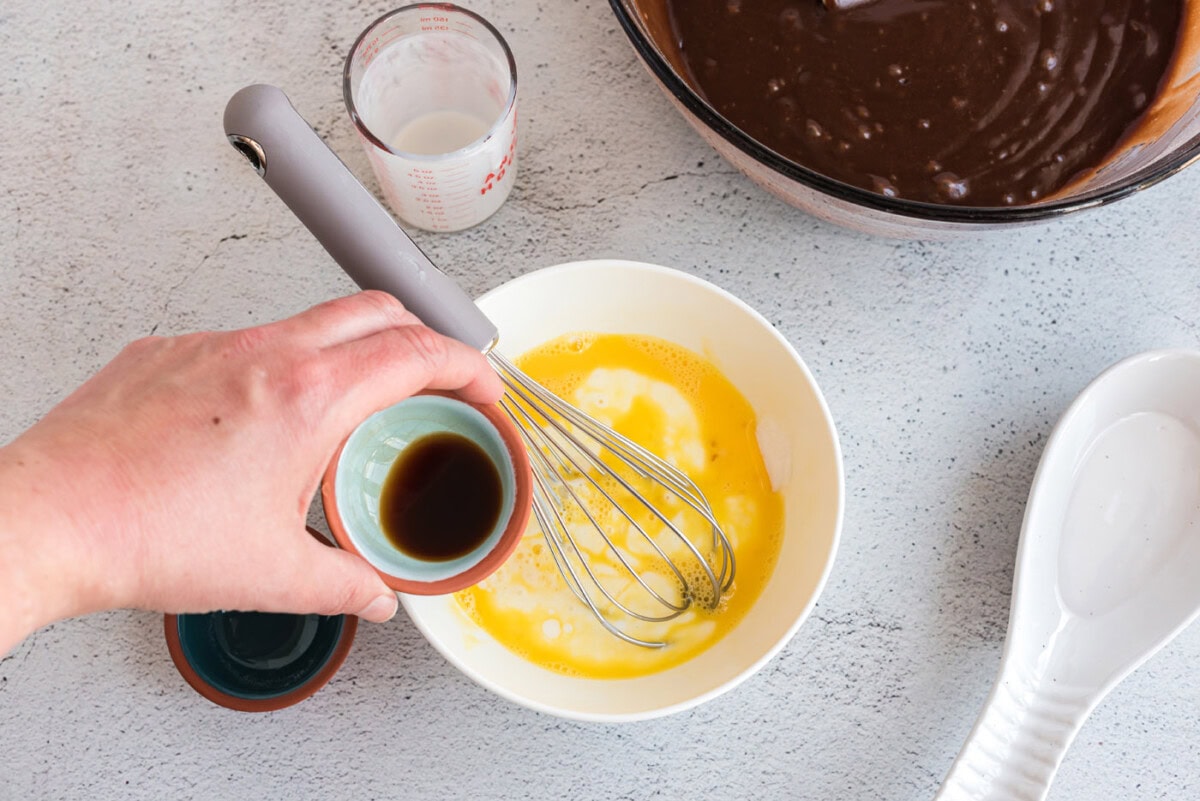 buttermilk, egg, baking soda, and vanilla in a bowl with a whisk