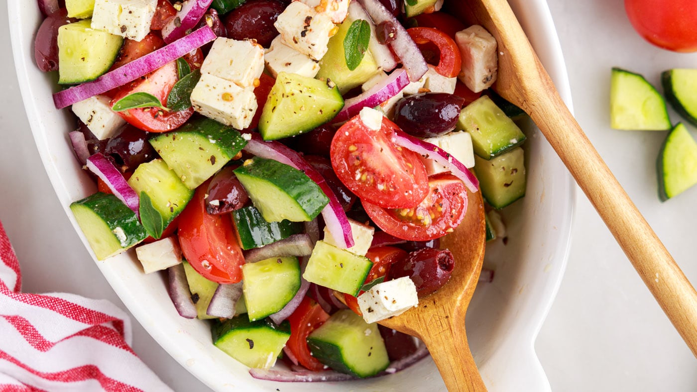Cucumber, tomato, feta, kalamata olives, and red onion are cubed and sliced then tossed in a lemon j