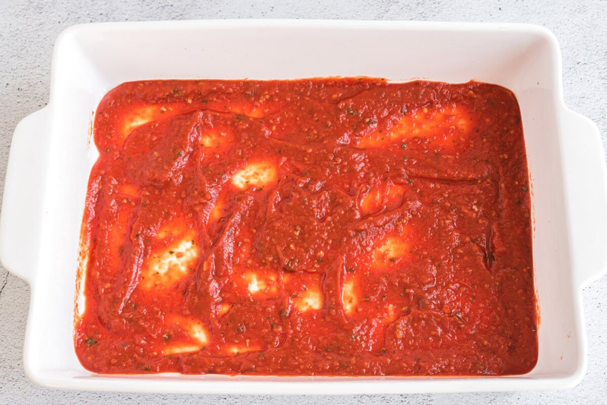 toamato sauce on bottom of baking dish