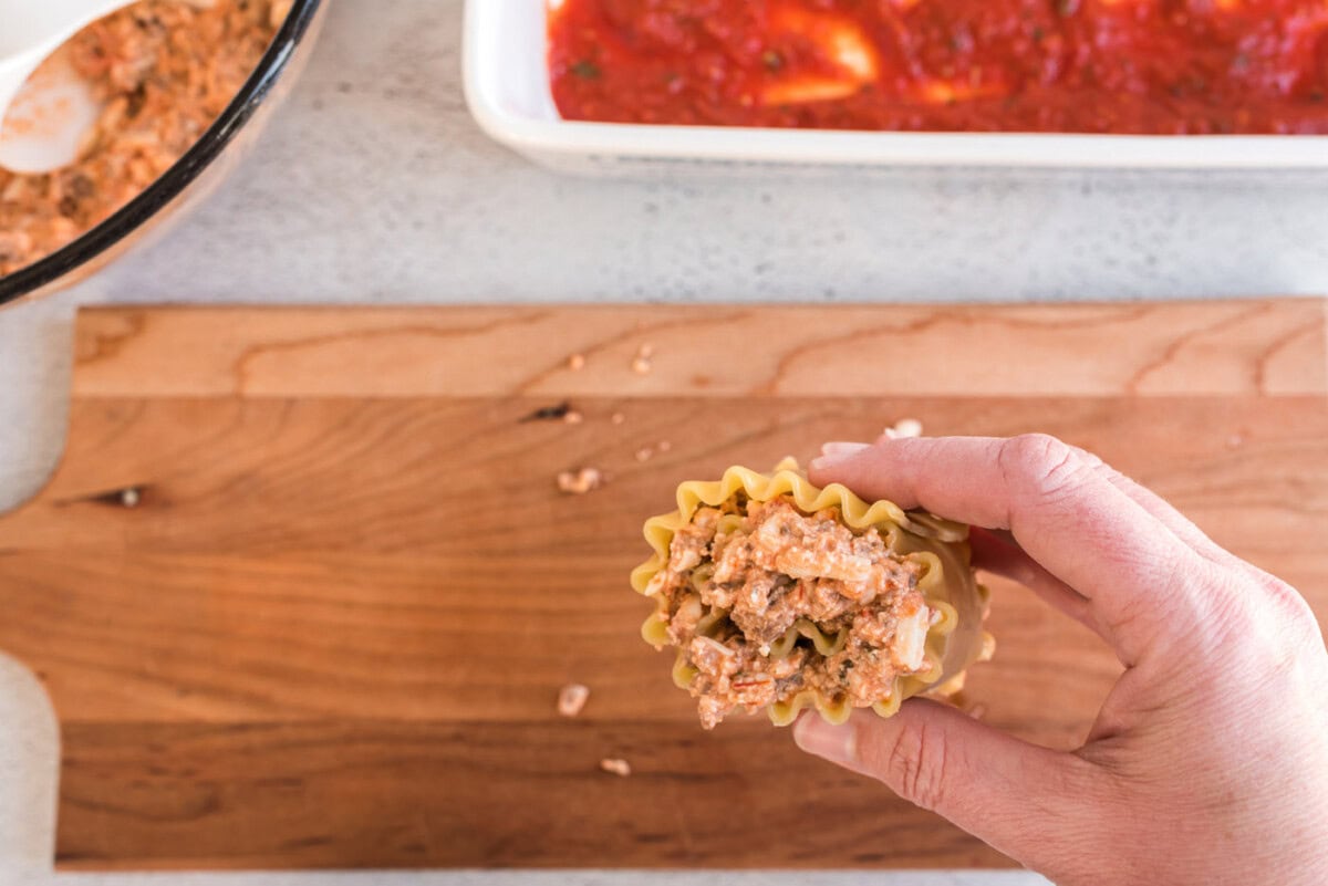 hand holding lasagna roll up