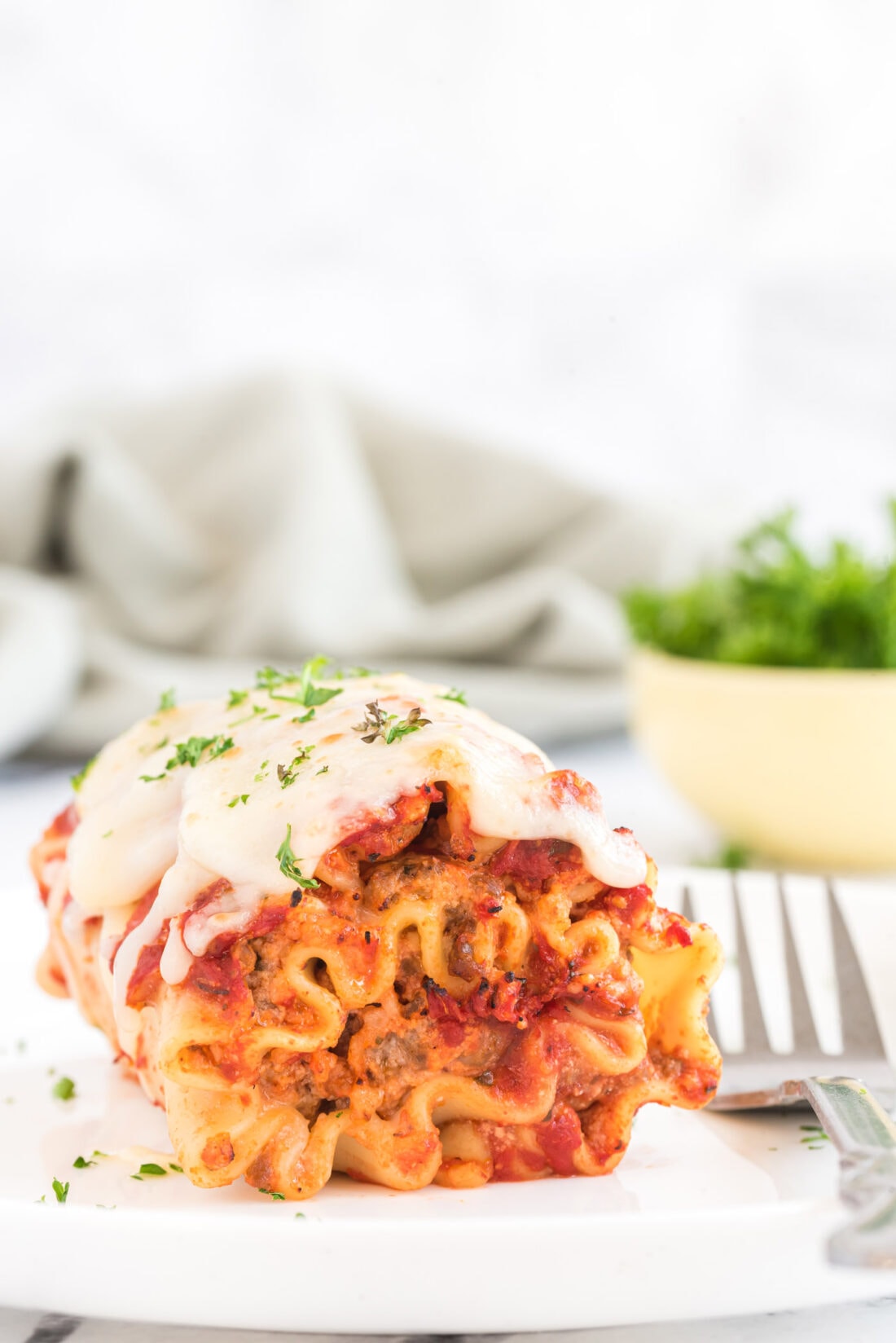 Lasagna Roll Up with a fork on a plate