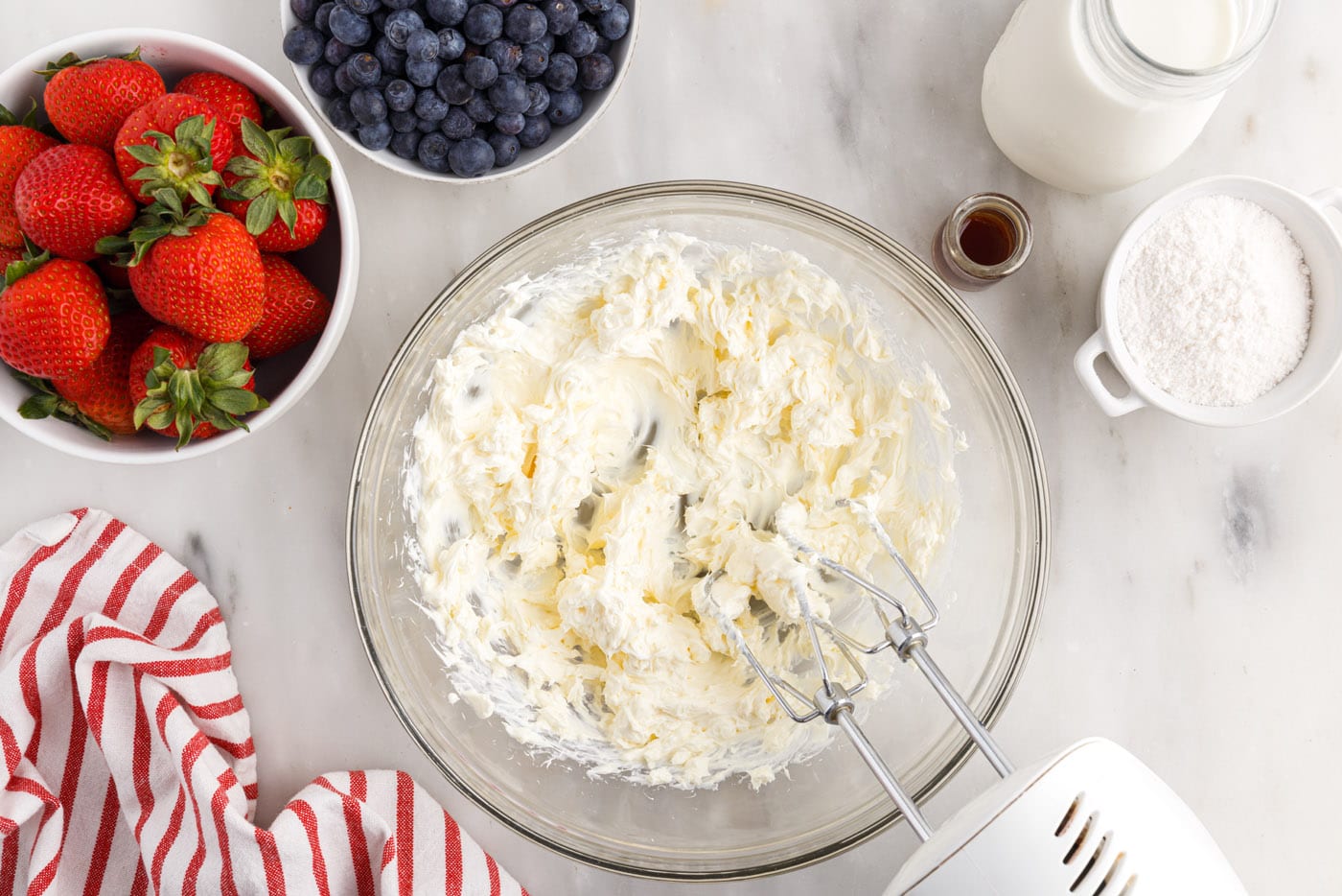 cream cheese beaten in a bowl with a mixer