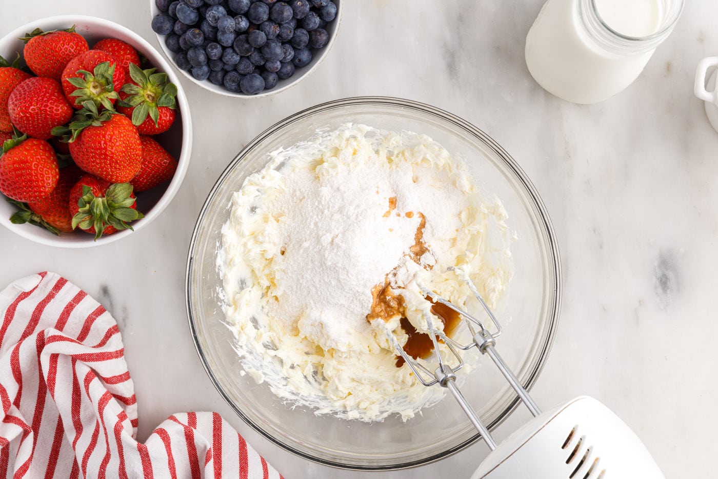 cream cheese, pudding mix, milk, and vanilla mixed in a bowl