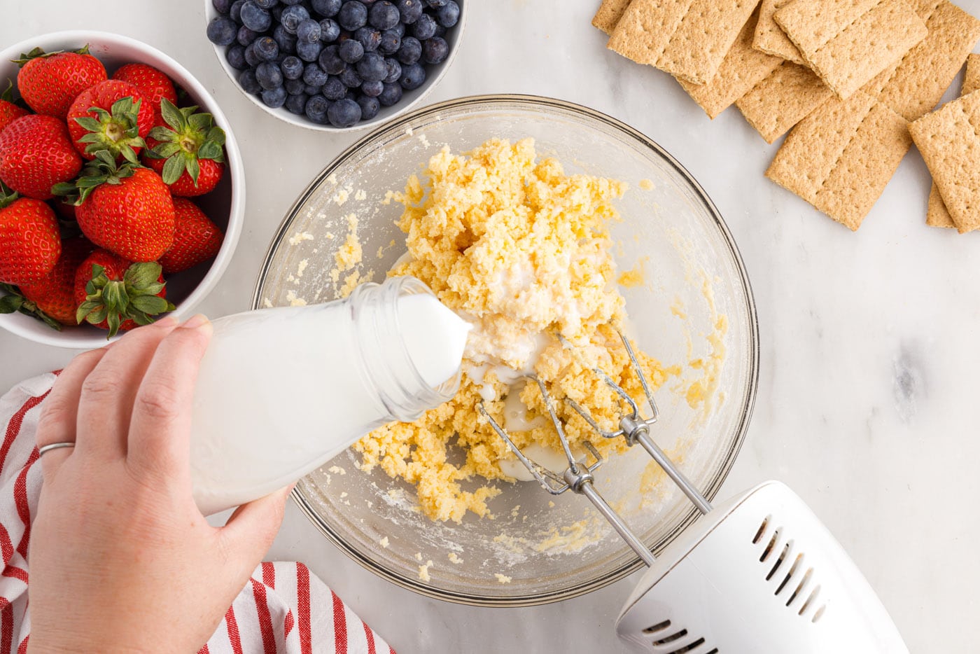 adding milk to cream cheese mixture