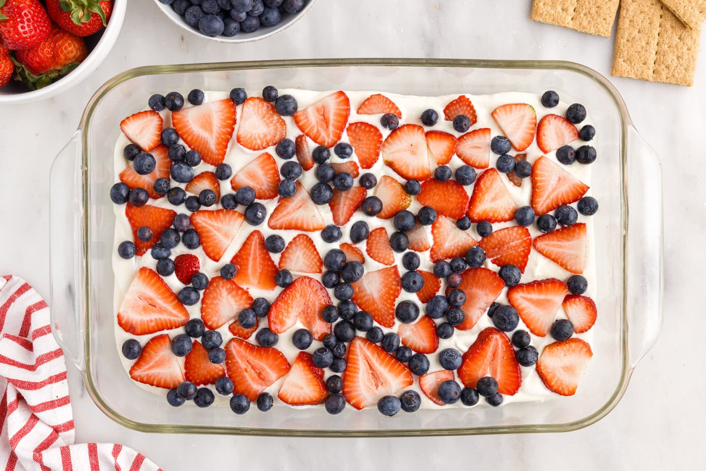 layer of strawberries and blueberries over cream cheese pudding mixture
