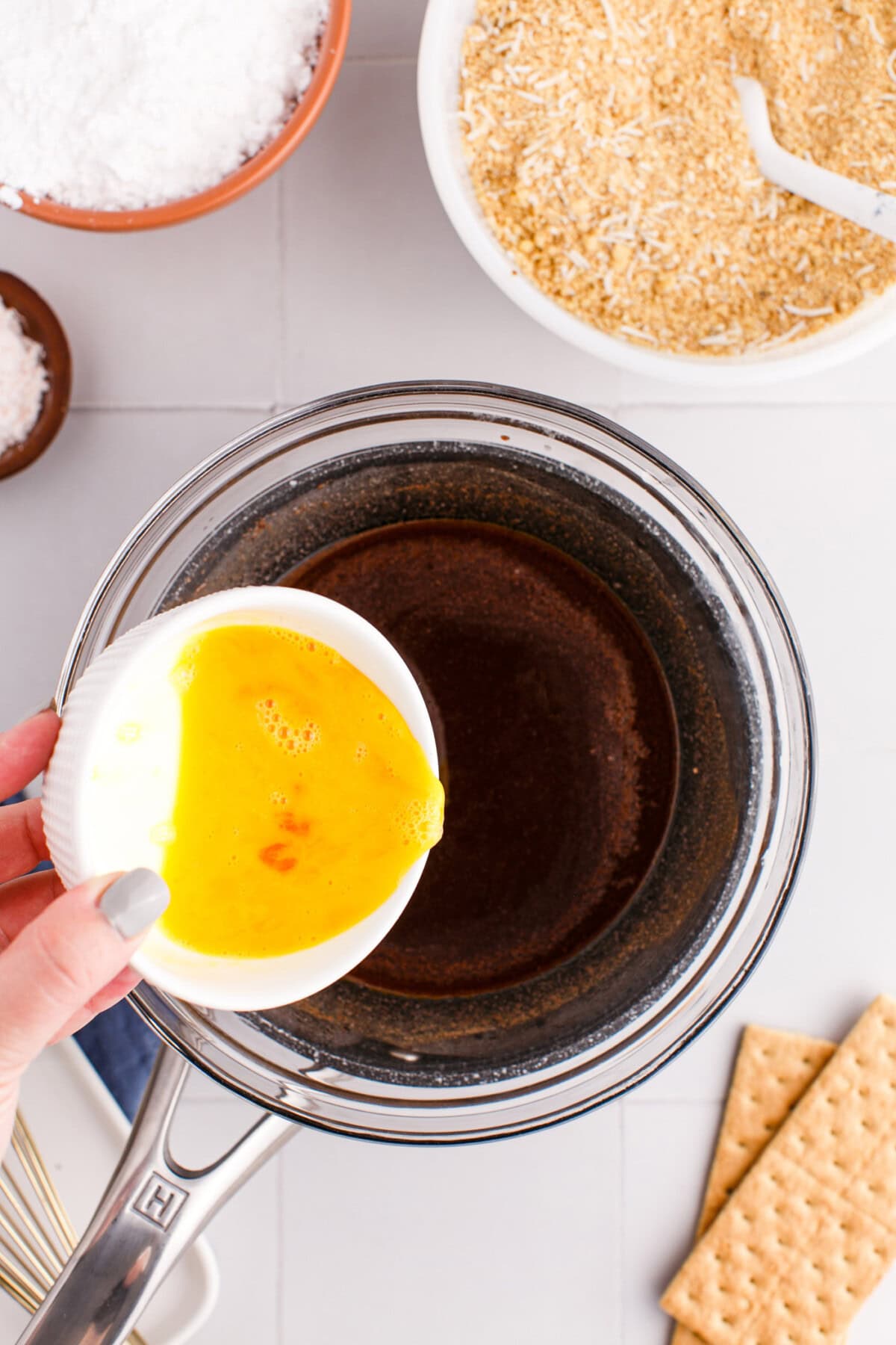 adding egg to melted cocoa and butter mixture