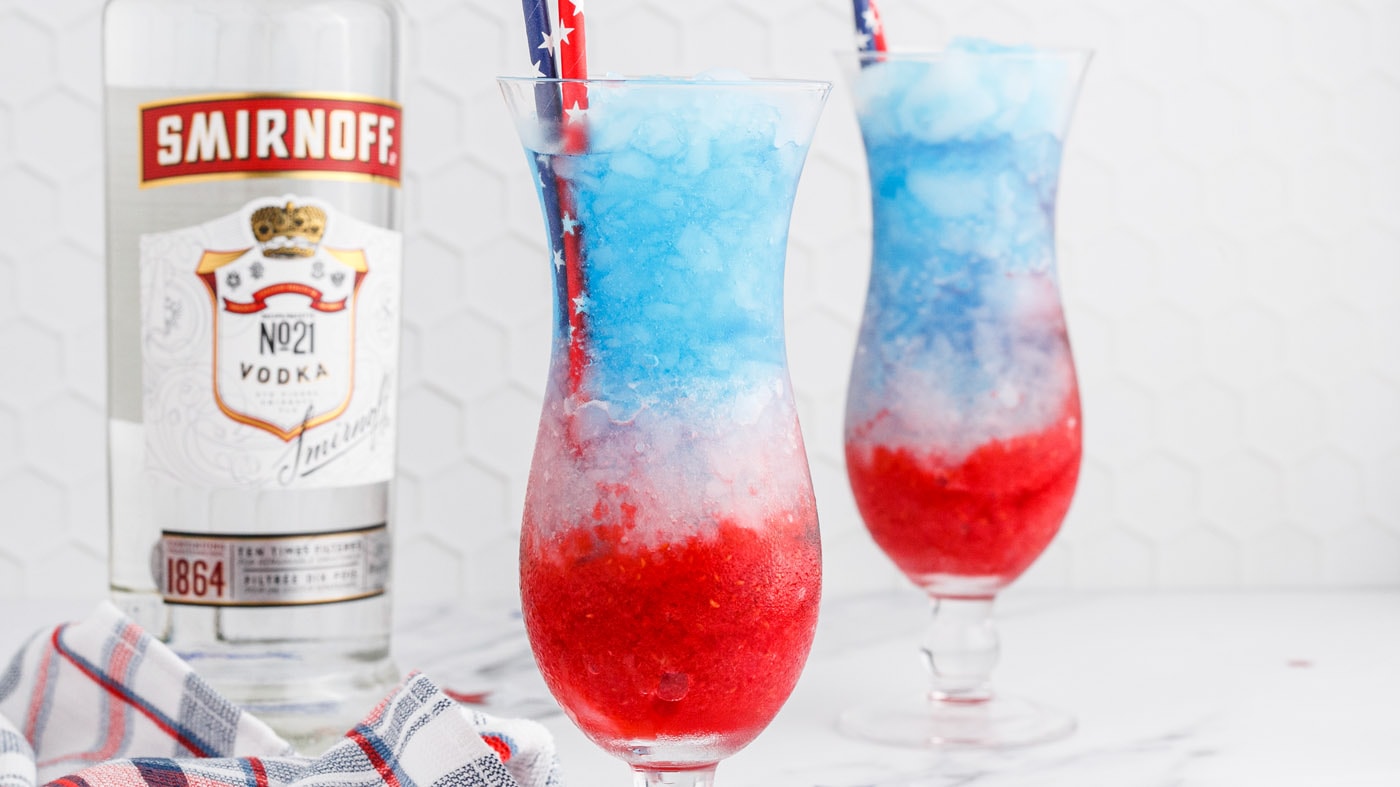 This patriotic vodka lemonade slushie brings the festive red, white, and blue colors together in a r