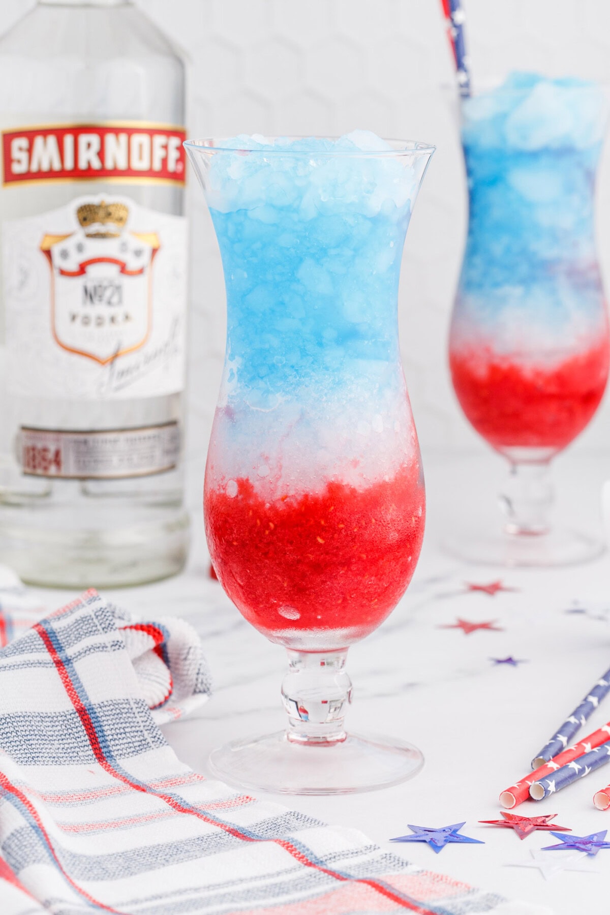 layers of raspberry, lemonade, and blue curacao in a drink glass