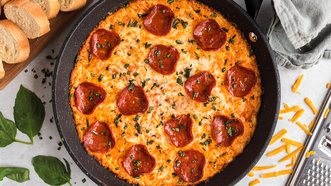 On the bottom of this pizza dip, you have a layer of triple-cheese decadence topped with Italian-sty