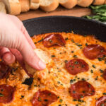 dipping bread into pizza dip