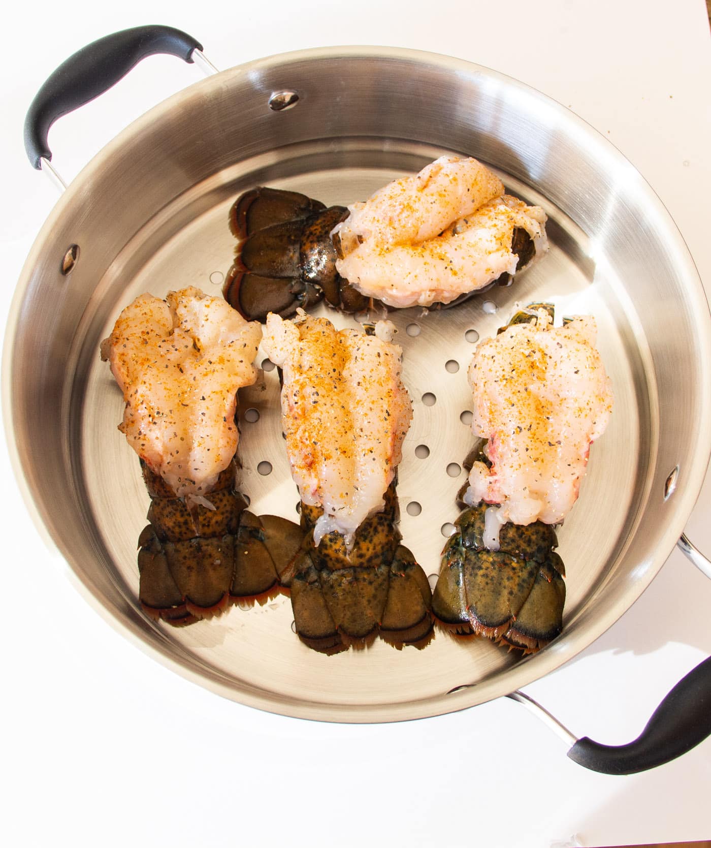 crowned lobster tails in a steam pot