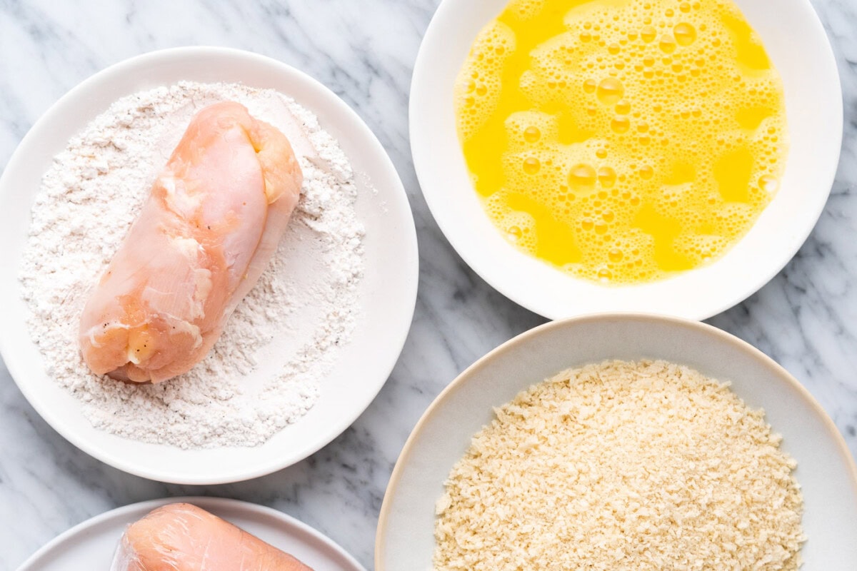 rolling chicken cordon bleu into flour mixture
