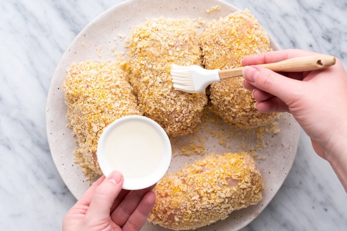brushing oil onto chicken cordon bleu