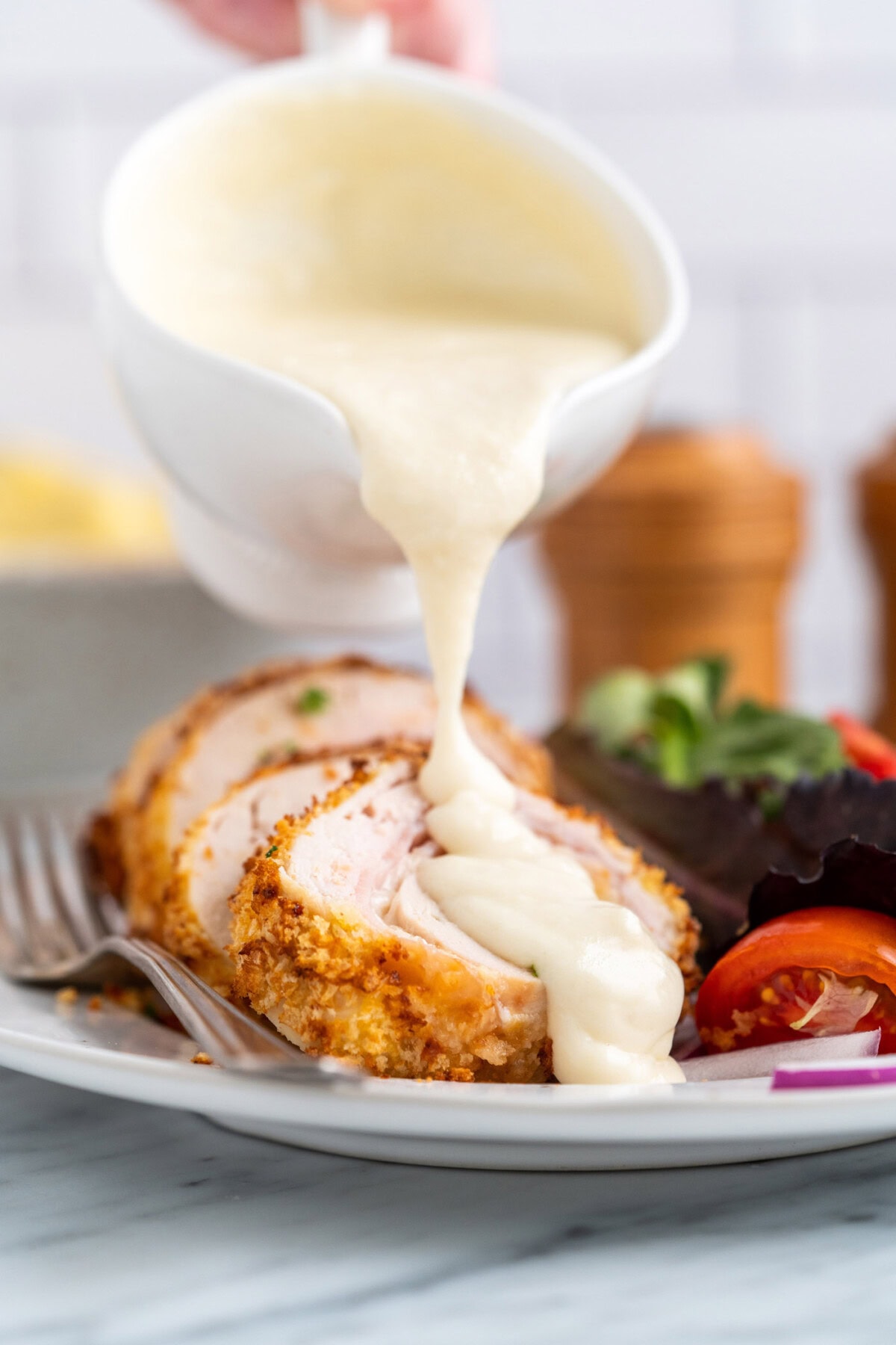 drizzling sauce on Air Fryer Chicken Cordon Bleu