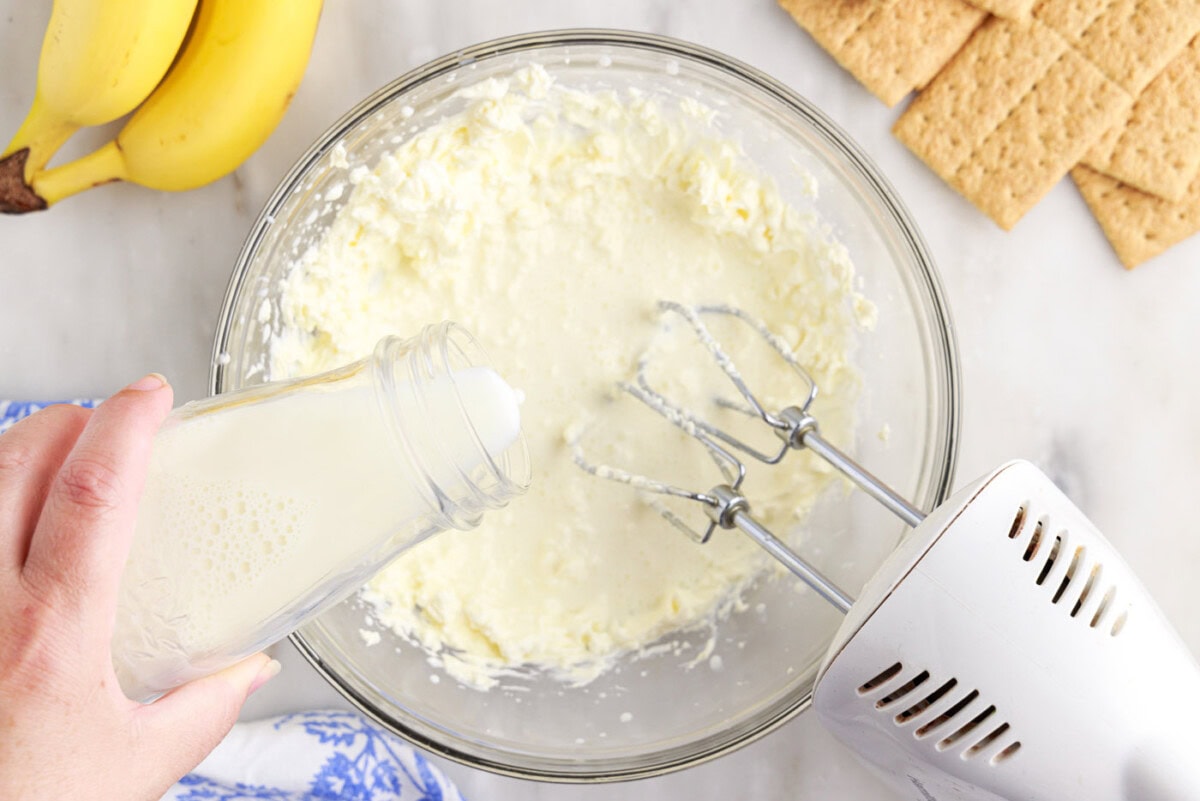 pouring milk into cream cheese mixture