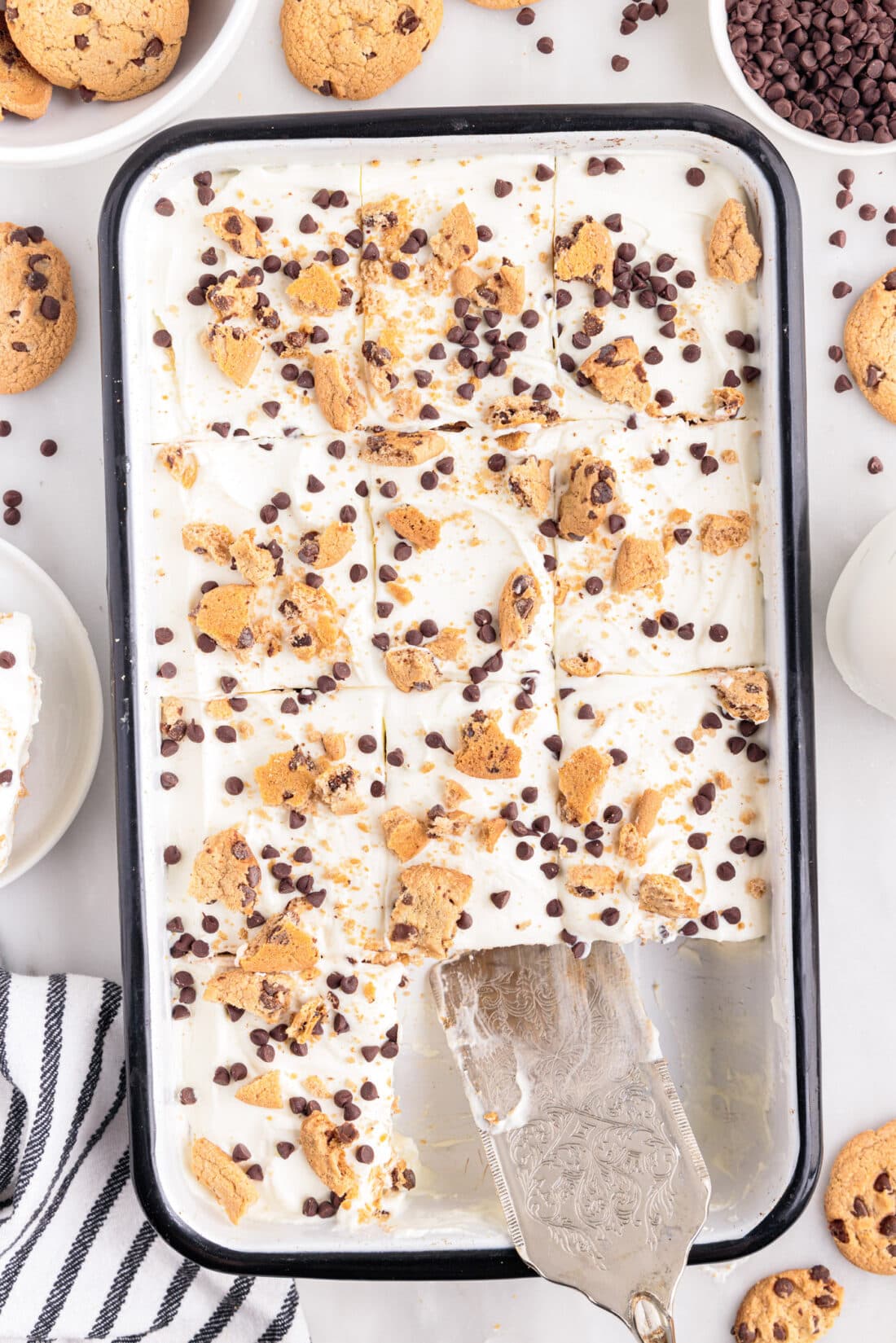 pan of Chocolate Chip Cookie Icebox Cake with spatula