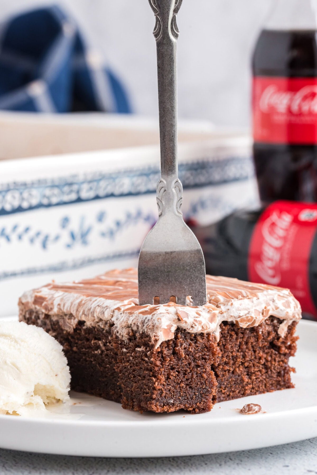 Forking standing up in a slice of Cracker Barrel Coca Cola Cake