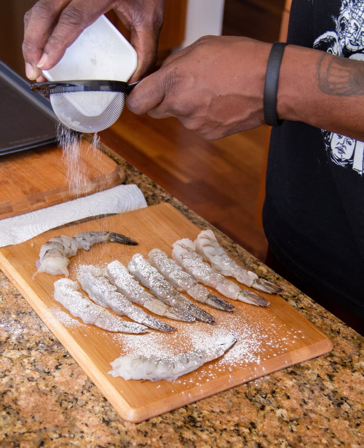 sifting cornstarch over shrimp