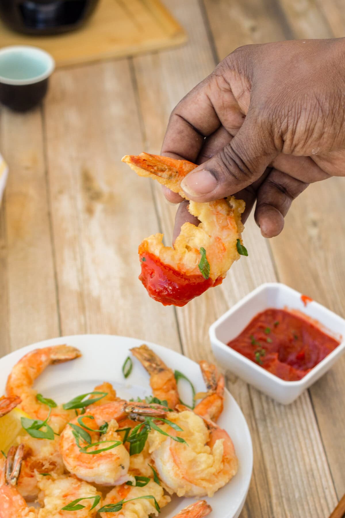 dipping Crispy Shrimp in cocktail sauce