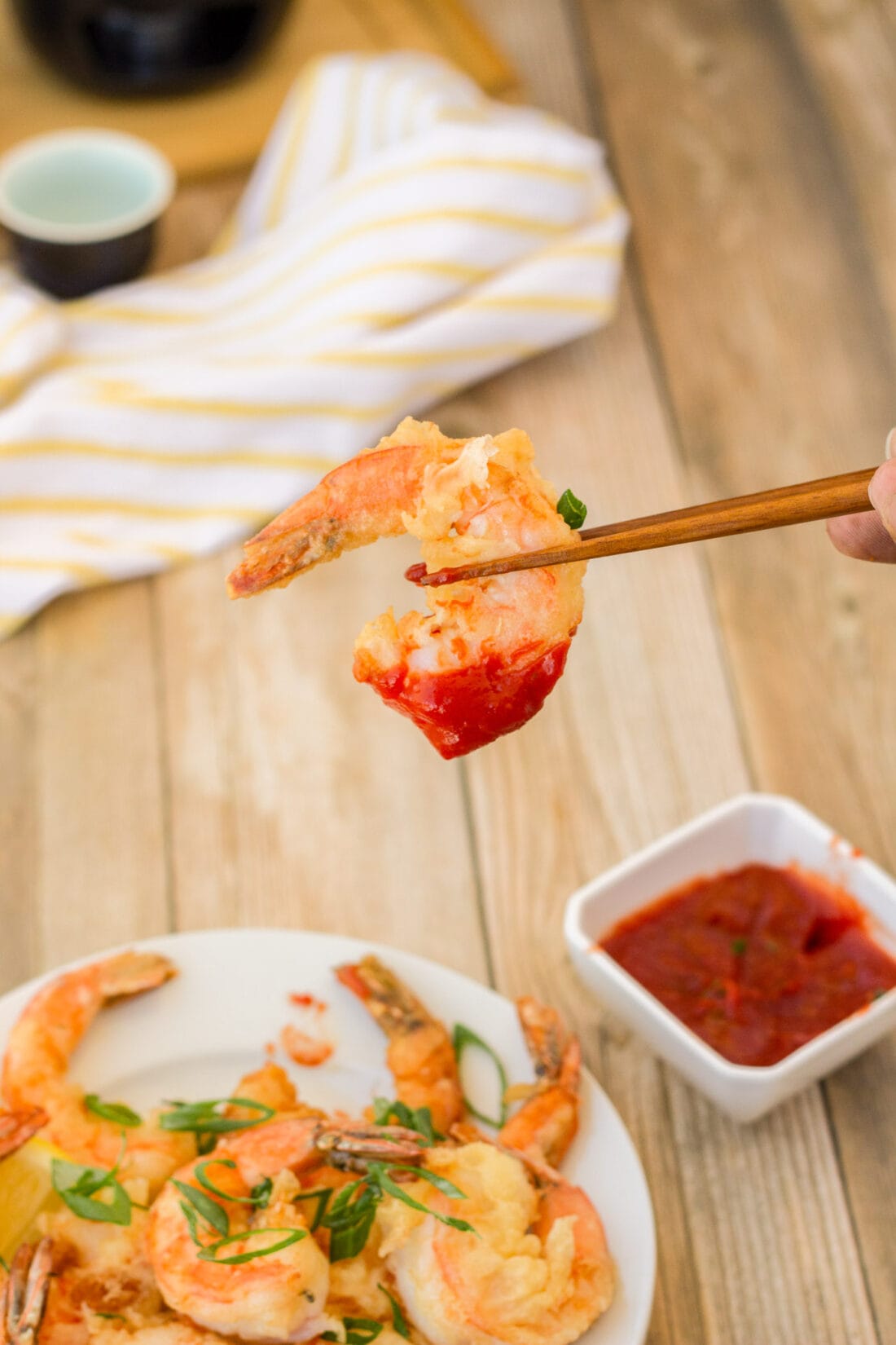 holding a Crispy Shrimp with chopsticks