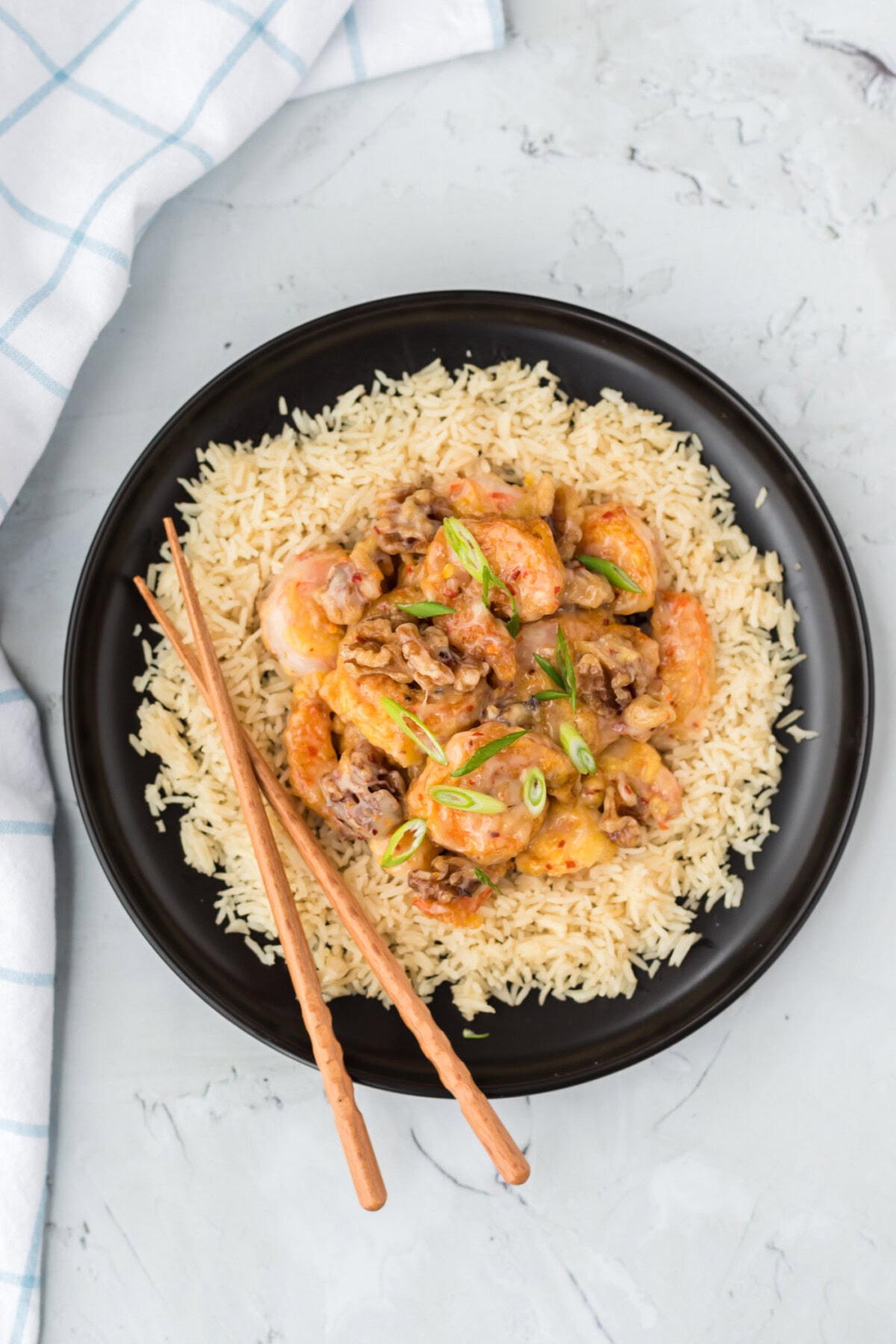 plate of Honey Walnut Shrimp with rice and chopsticks