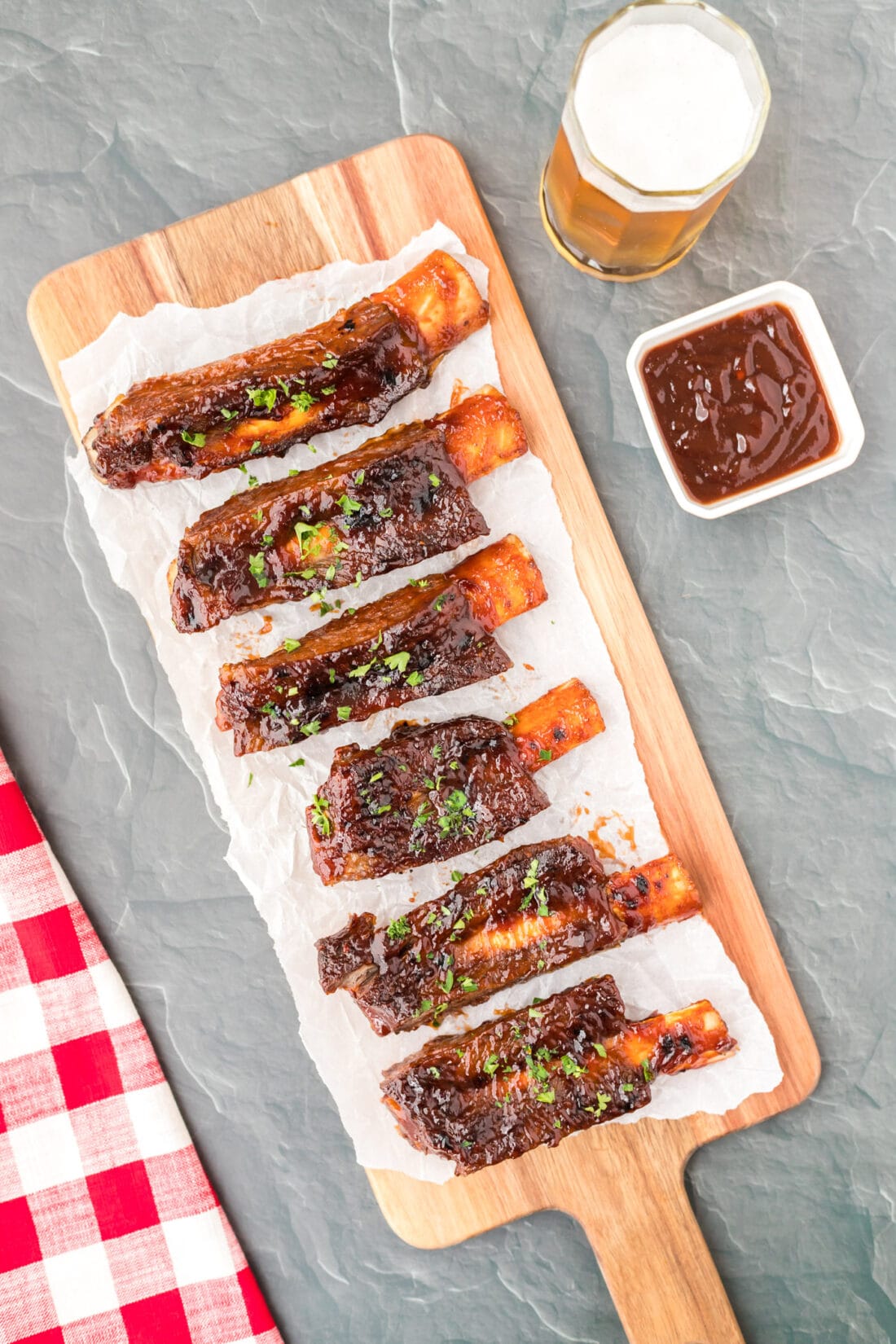 Instant Pot Beef Ribs on cutting board with sauce