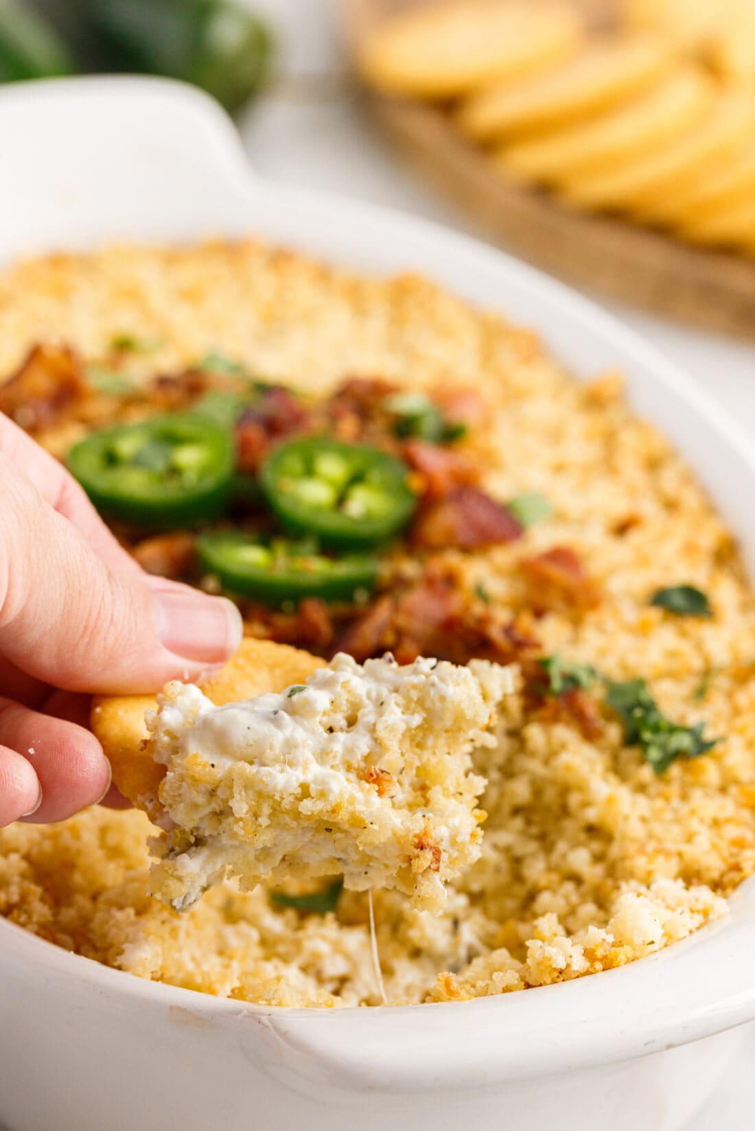lifting Jalapeno Popper Dip with a cracker