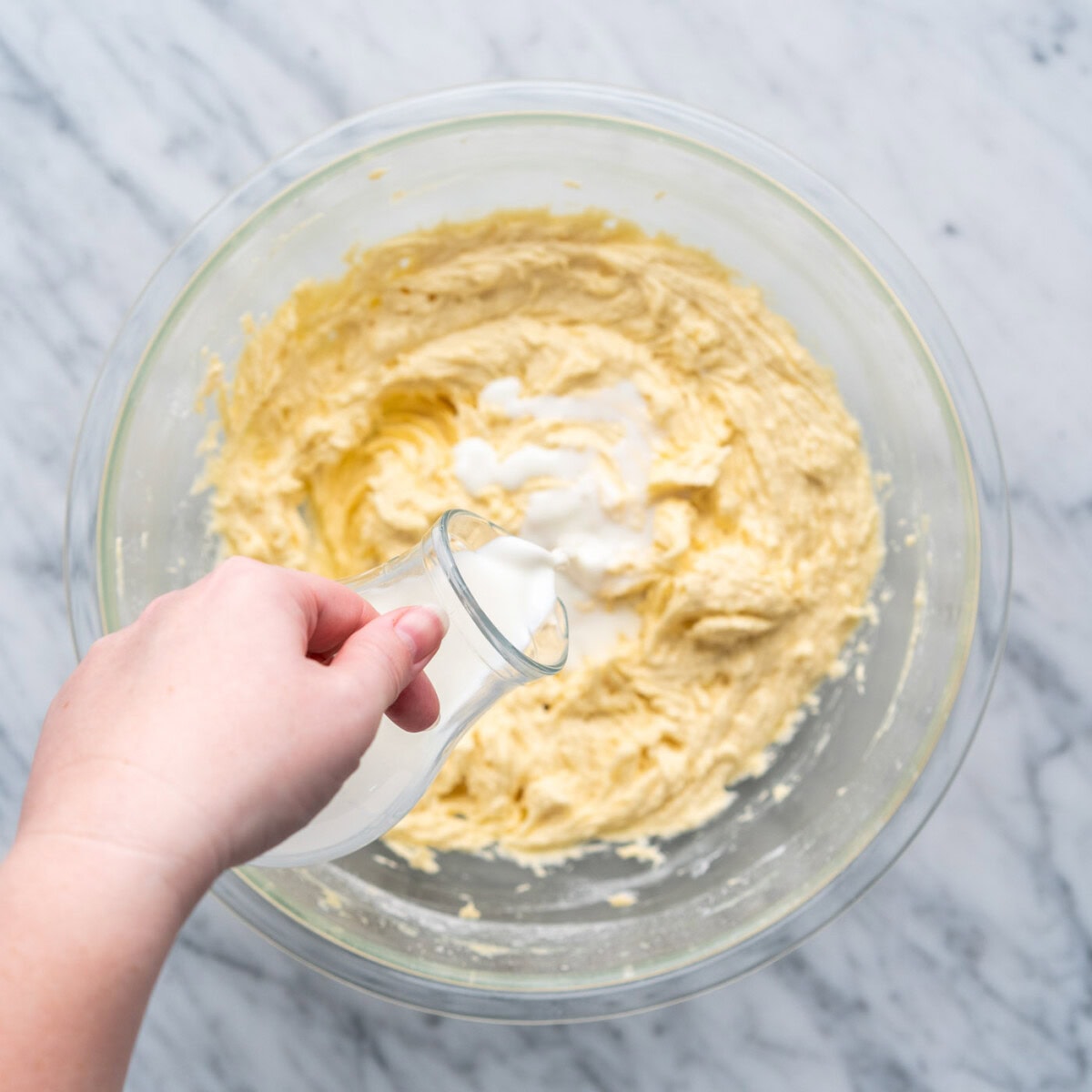 adding milk to yellow cake batter