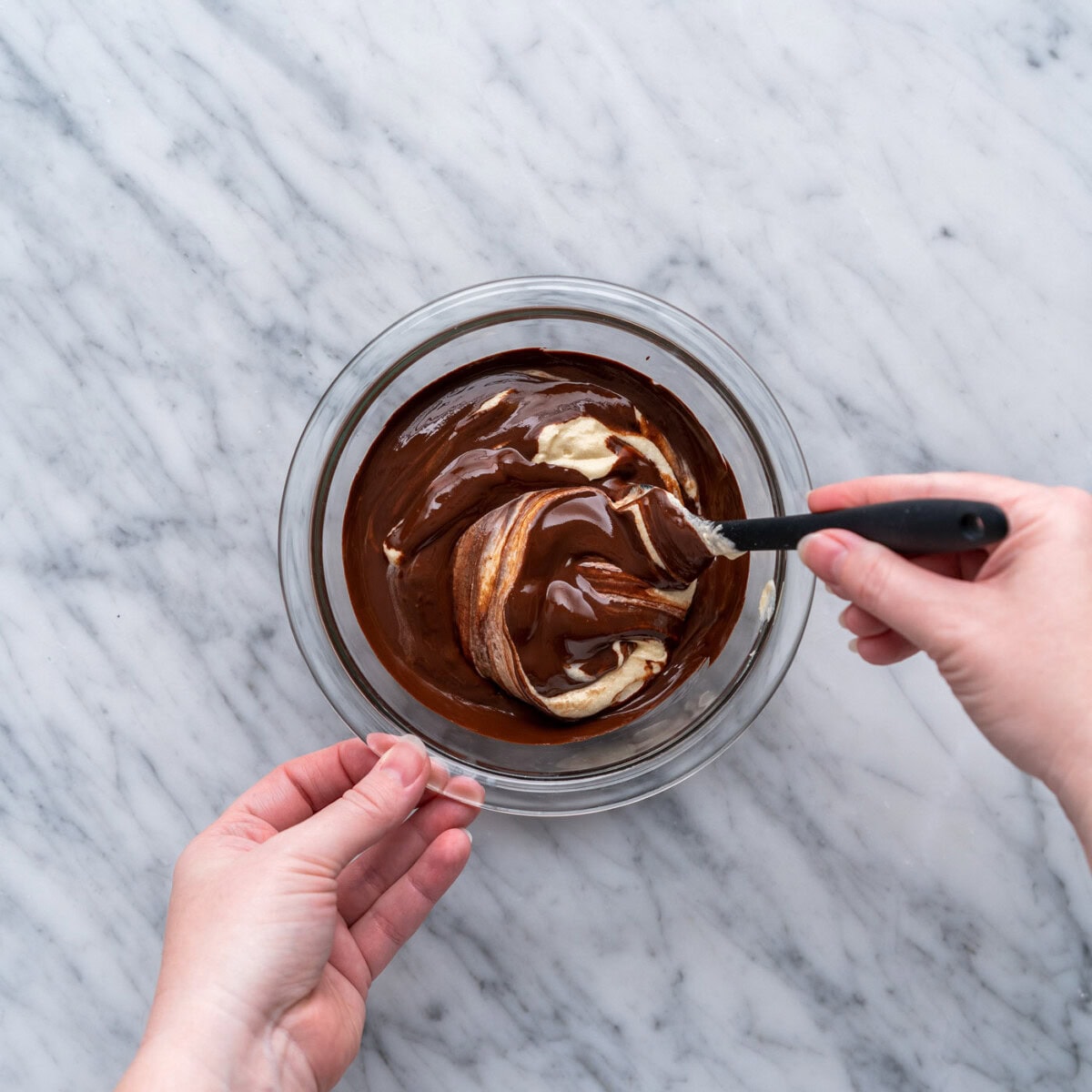 stirring melted chocolate into yellow cake batter